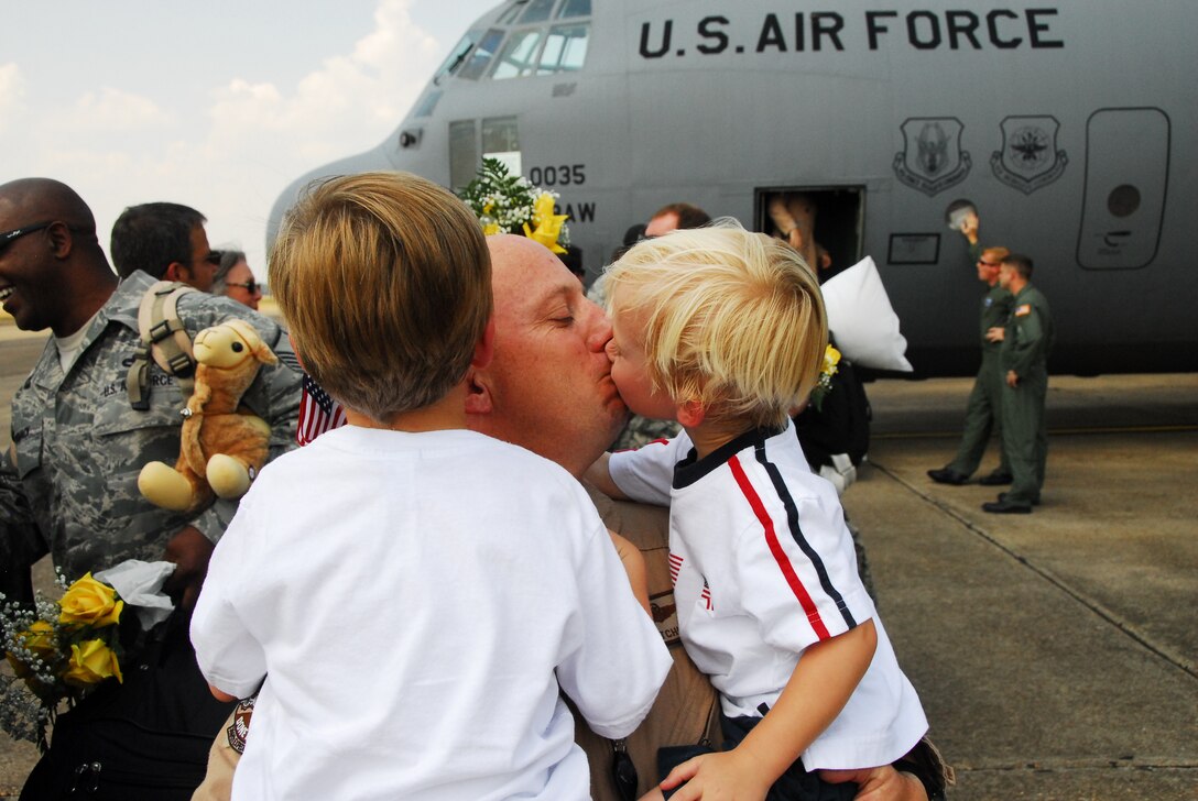 Lt. Col. Steve Catchings greets his sons after his return to Maxwell AFB. Approximately 150 members of the 908th Airlift Wing recently returned from a four-month deployment to Southwest Asia. (Air Force photo by Gene H, Hughes)
