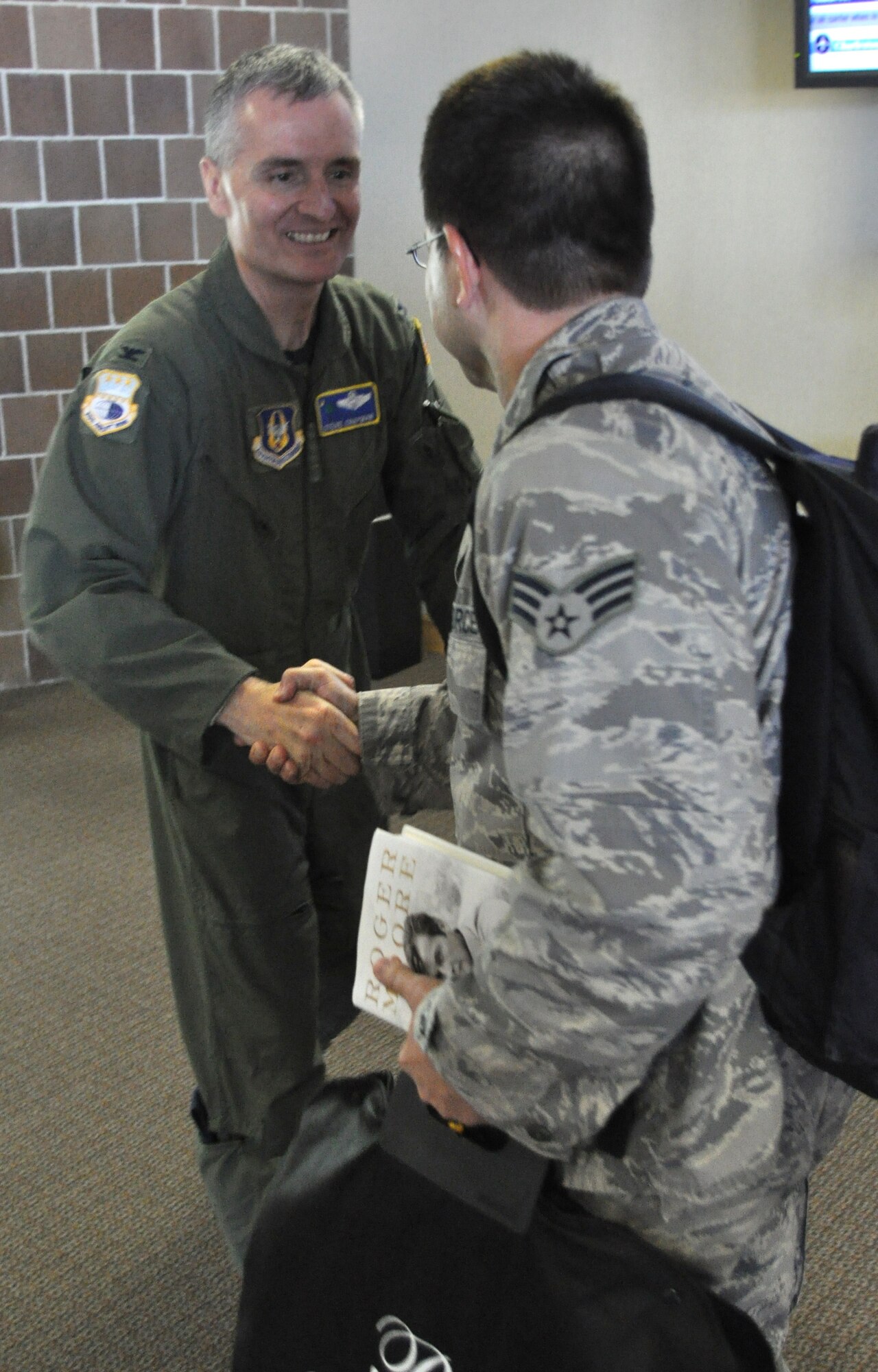 Senior Airman Joseph McClendon is greeted by Col. Steven Chapman Sept. 23, 2010 upon returning to Charleston, S.C. after a four month deployment to locations in Southwest Asia. Airman McClendon is with the 38th Aerial Port Squadron and Colonel Chapman is the 315th Airlift Wing commander at Charleston Air Force Base, S.C. (U.S. Photo/Staff Sgt. Shane Ellis)