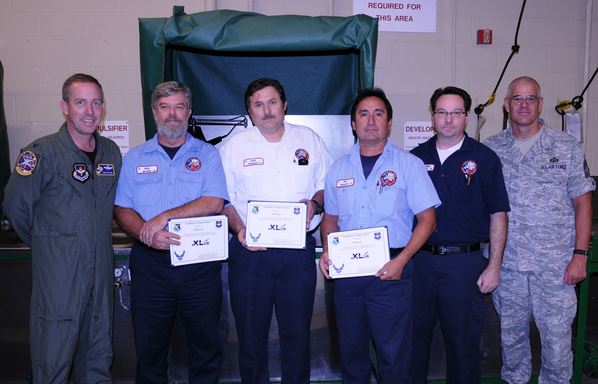 LAUGHLIN AIR FORCE BASE, Texas – Rick Myers, Mike Peabody, Joe Burato and Matthew Letts, all of the 47th Maintenance Directorate, pose with Col. Michael Frankel, 47th Flying Training Wing commander, and Chief Master Sgt. Mike Hanning, 47th FTW command chief, after Col. Frankel presented their unit the XLer of the Week award here Sept. 22. The XLer is chosen by wing leadership and given to individuals and units who continuously make outstanding contributions to Laughlin. (U.S. Air Force photo by Airman 1st Class Blake Mize) 
