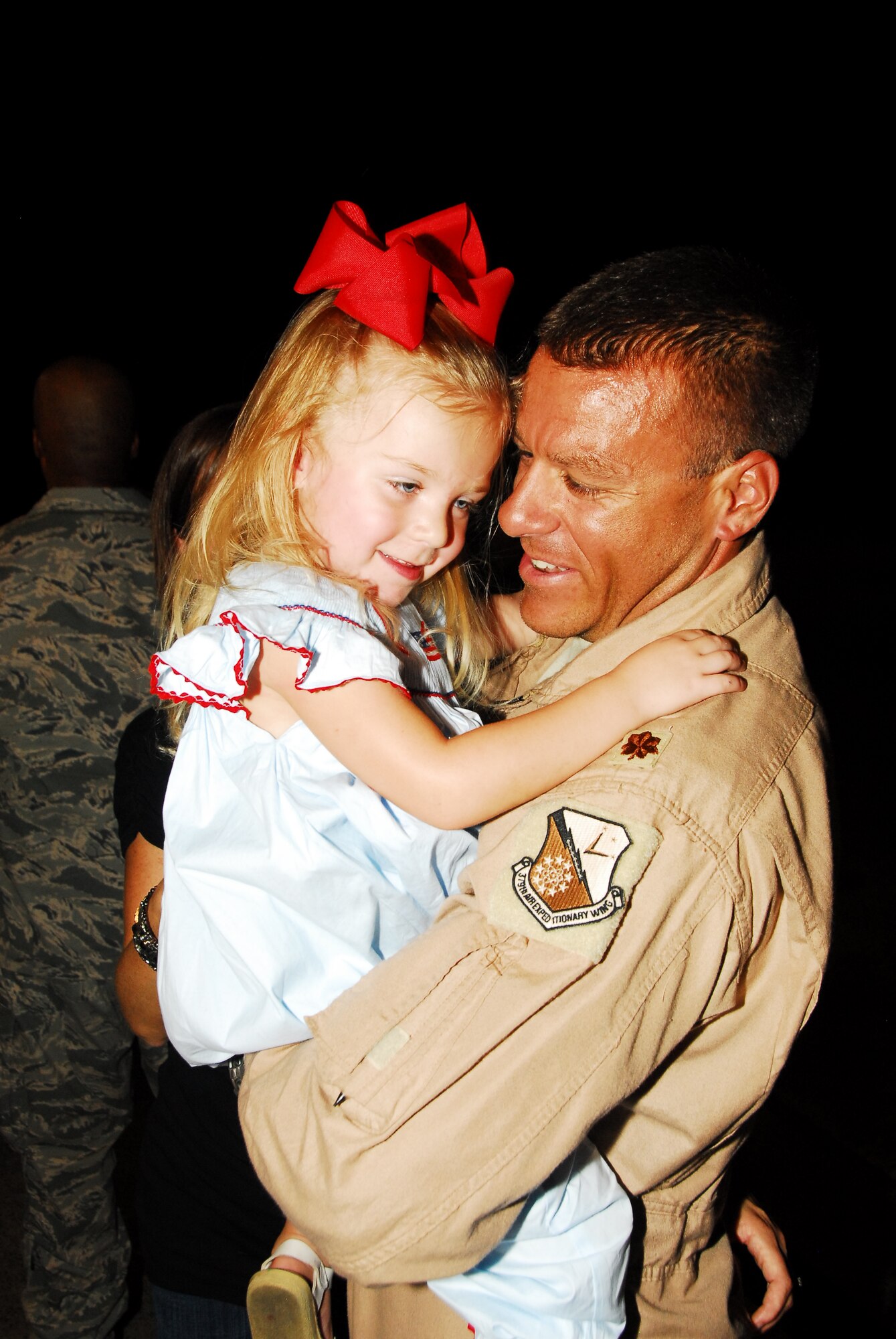 Keira greets her father, Maj. Delvin Gerenbacher, upon his return to Maxwell AFB. Approximately 150 members of the 908th Airlift Wing recently returned from a four-month deployment to Southwest Asia. (Air Force photo by Gene H. Hughes)