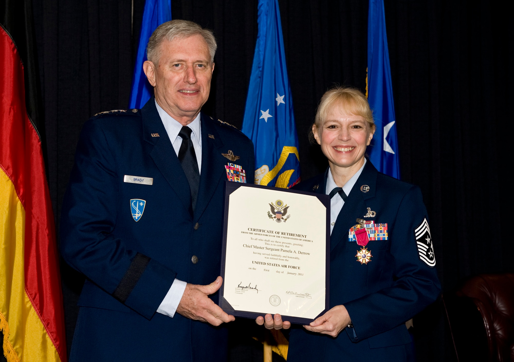 Gen. Roger A. Brady, U.S Air Force in Europe commander, presents the Certificate of Retirement to Chief Master Sgt.  Pamela A. Derrow, USAFE command chief, during a ceremony at Ramstein Air Base, Germany, Sept. 27, 2010. Chief Derrow retired after nearly 31 years in the Air Force. (U.S. Air Force photo/Tech. Sgt. Wayne Clark)