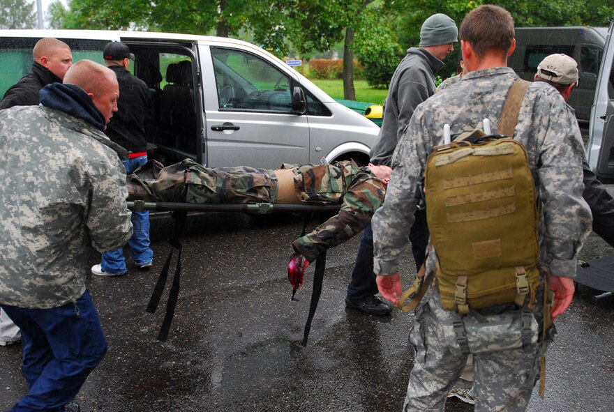 A simulated casualty with electrical burns is transported to the 21st Tactical Airbase medical clinic during a mass casualty training exercise held Sept. 18 in Swidwin, Poland during the Jackal Stone 10 Exercise. Jackal Stone 10, hosted by Poland and Lithuania this year, is an annual international special operations forces exercise held in Europe. Its objective is to enhance capabilities and interoperability amongst the participating special operations forces and build mutual respect while sharing doctrinal concepts. The exercise, which is coordinated with U.S. Special Operations Command Europe, includes countries from Poland, Lithuania, Latvia, Croatia, Romania and Ukraine. (U.S. Army photo/Staff Sgt. Shelia L. Sledge)