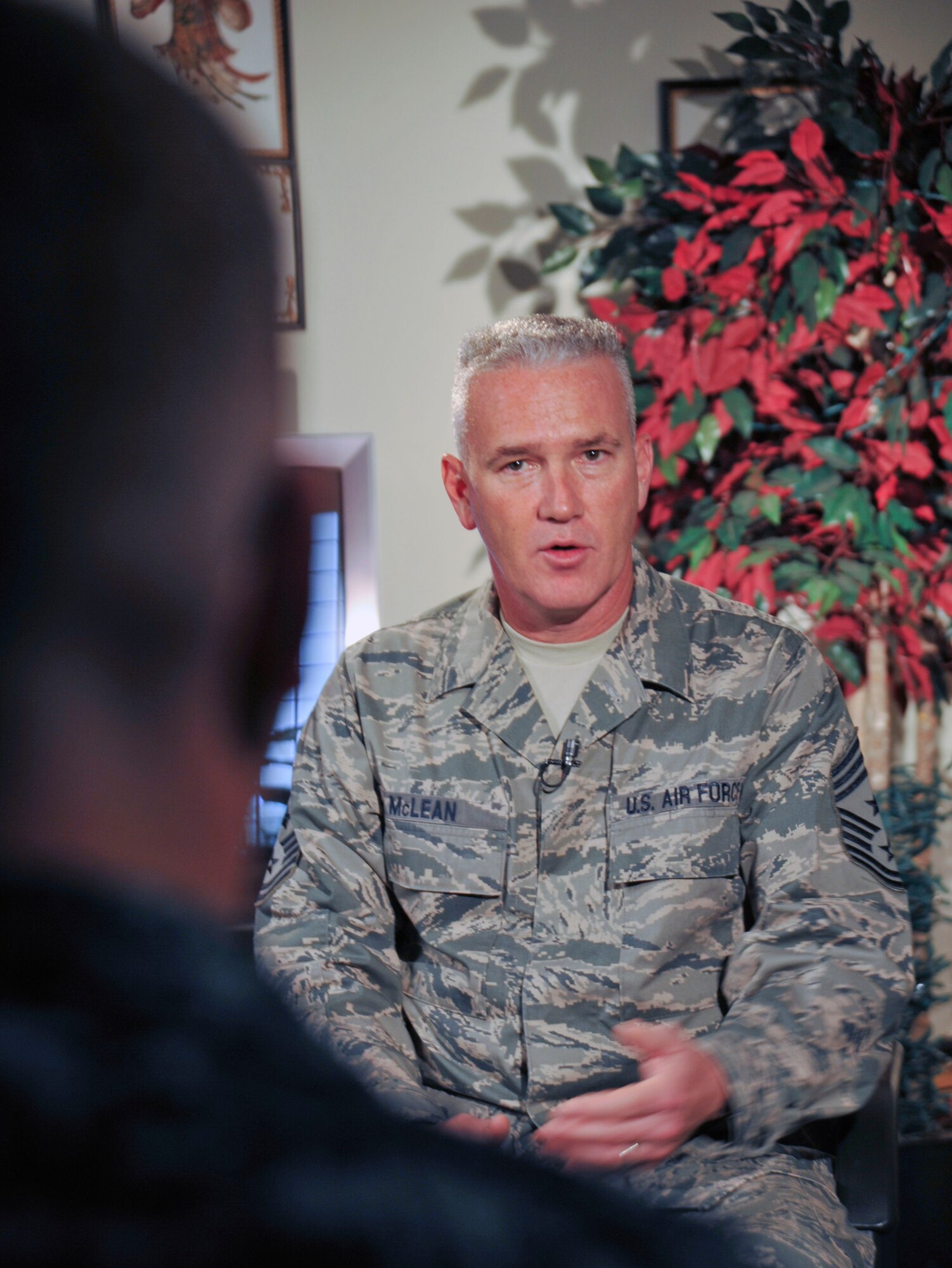 Chief Master Sergeant Brooke McLean, command chief of Pacific Air Forces, answers questions during an interview at the Armed Forces Network facility at Misawa Air Base, Japan, Sept. 23, 2010. CMSgt McLean also celebrated Misawa's 63rd Air Force Ball (U.S. Air Force photo by Tech. Sgt. Russell McBride/Released)