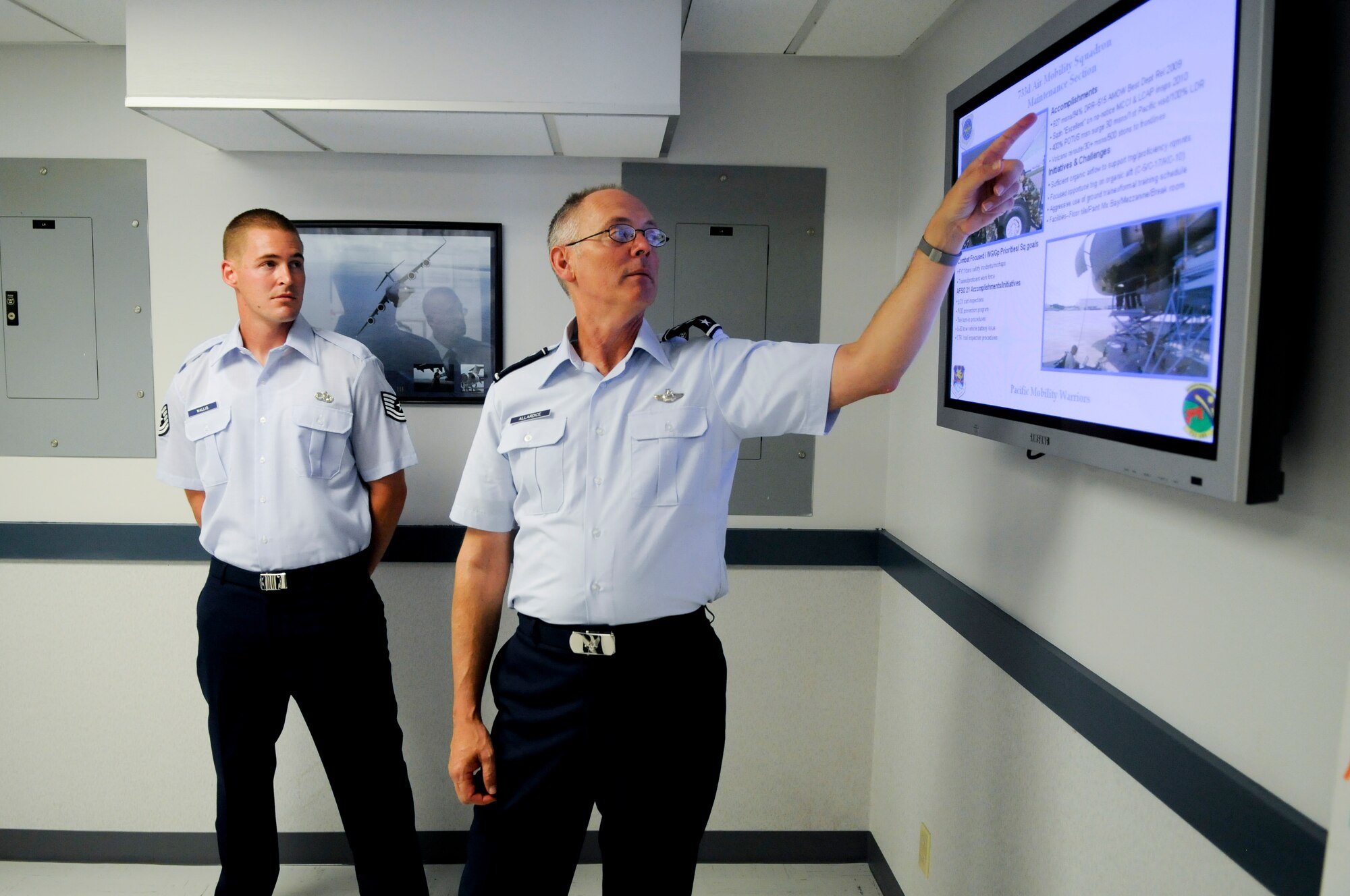 Lt. Gen. Robert Allardice, 18th Air Force commander, asks questions about the maintenance section of the 733d Air Mobility Squadron of Tech. Sgt. Joseph Wallis Sept. 27. Lt. Gen. Allardice took a tour of the 733d Air Mobility Squadron facilities and met Airmen there. (U.S. Air Force photo/Staff Sgt. Jonathan Steffen)