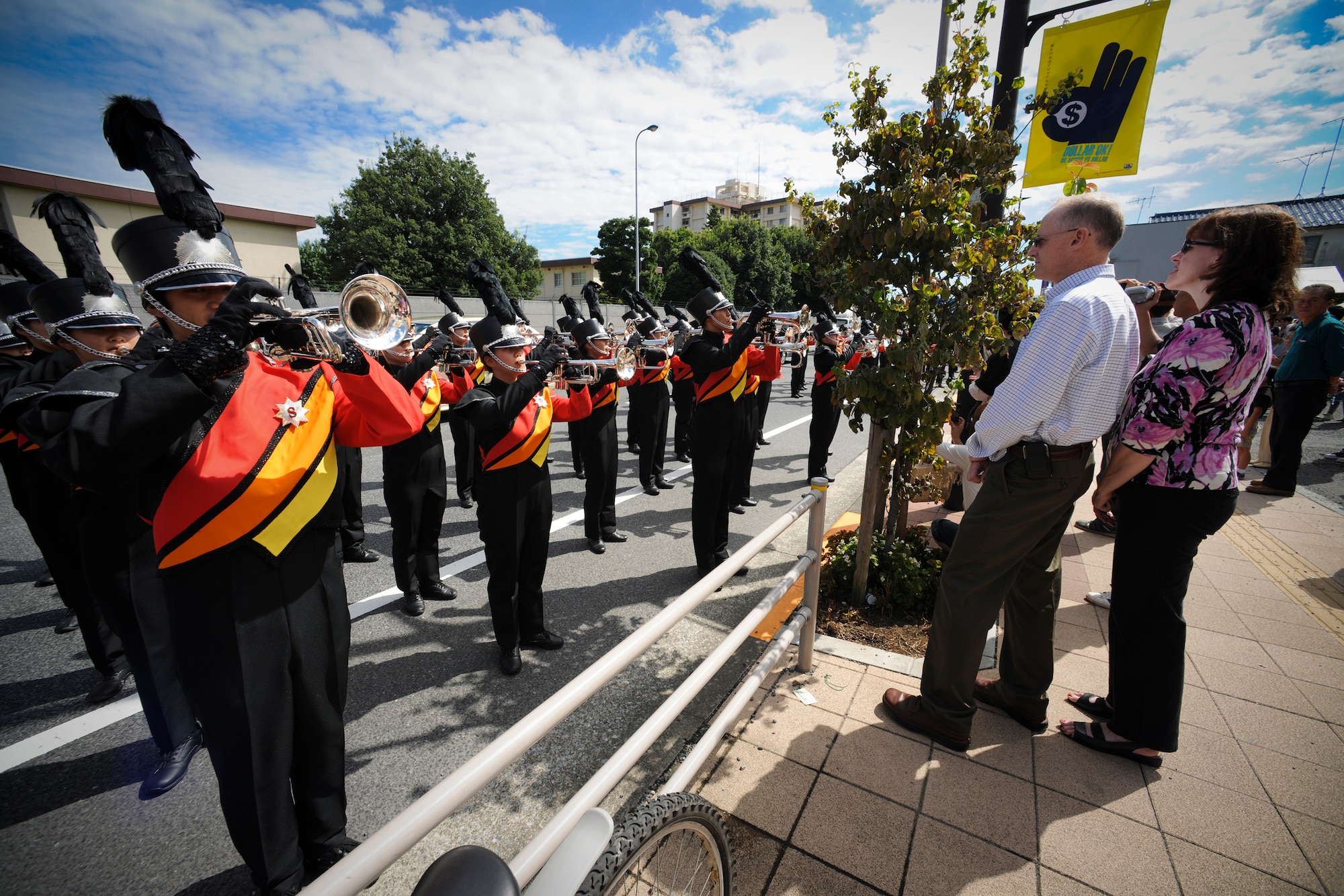 YOKOTA AIR BASE, Japan - Col. Otto Feather, 374th Airlift Wing Commander and his wife Nancy, enjoy a performance by members from Soka University Brass and Drums Corps. The band performed during the 2010 Fussa International Festival Parade, 26 Sept. (U.S. Air Force photo by Staff Sgt Stacy Moless)