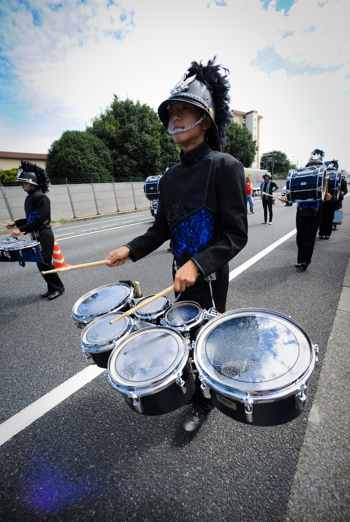 YOKOTA AIR BASE, Japan - A member of Genesis, a local Japanese marching band performs for packed city sidewalks right outside the gates of Yokota Air Base 26 Sept. Genesis was just one of four marching bands to volunteer to perform in the 2010 Fussa International Festival Parade. (U.S. Air Force photo by Staff Sgt Stacy Moless)
