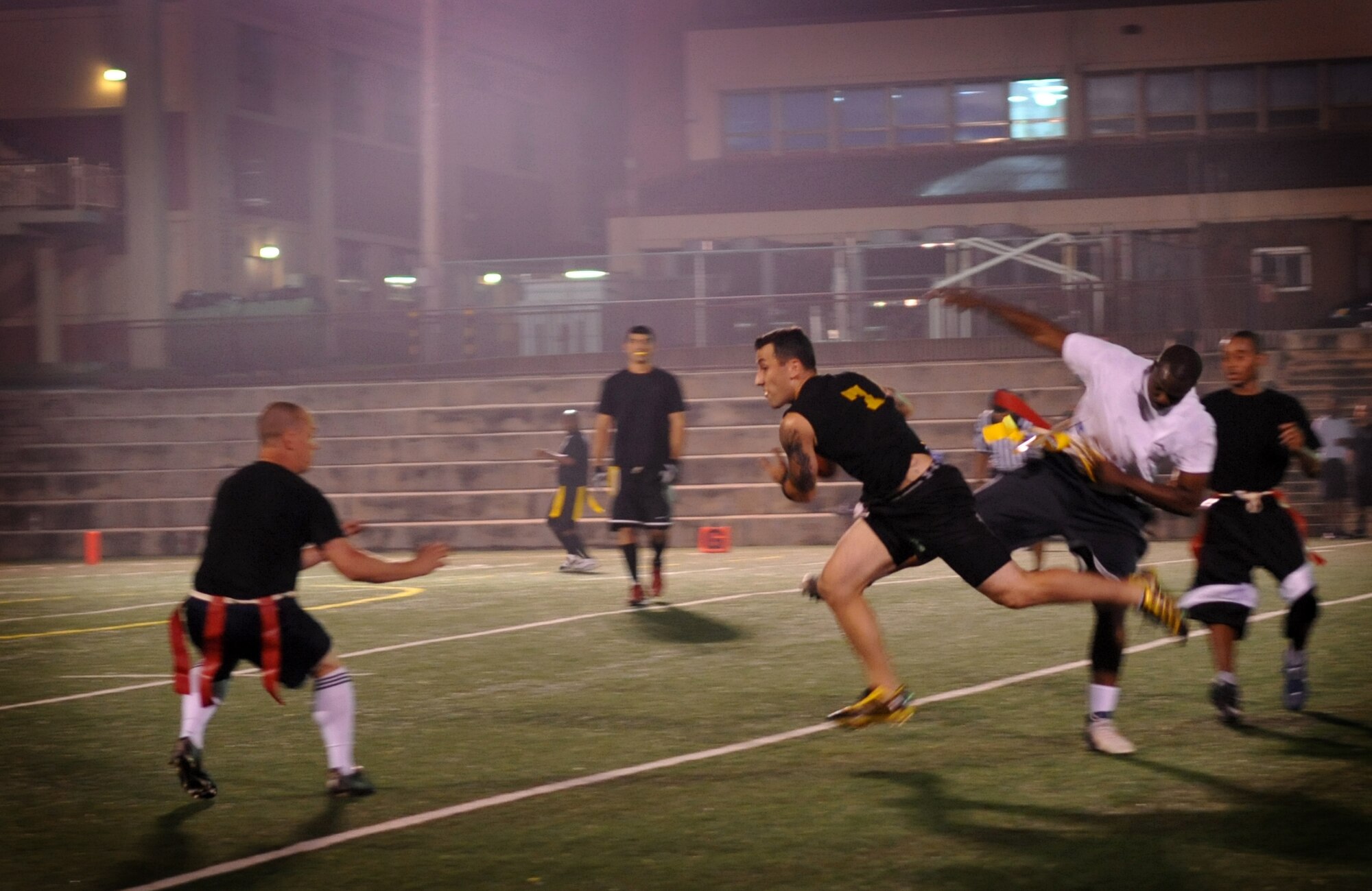 51st Communications Squadron and 51st Maintenance Operations Squadron Airmen compete during an intramural flag football game at Osan Air Base, Republic of Korea, Sept. 20. (U.S. Air Force photo/Senior Airman Evelyn Chavez)