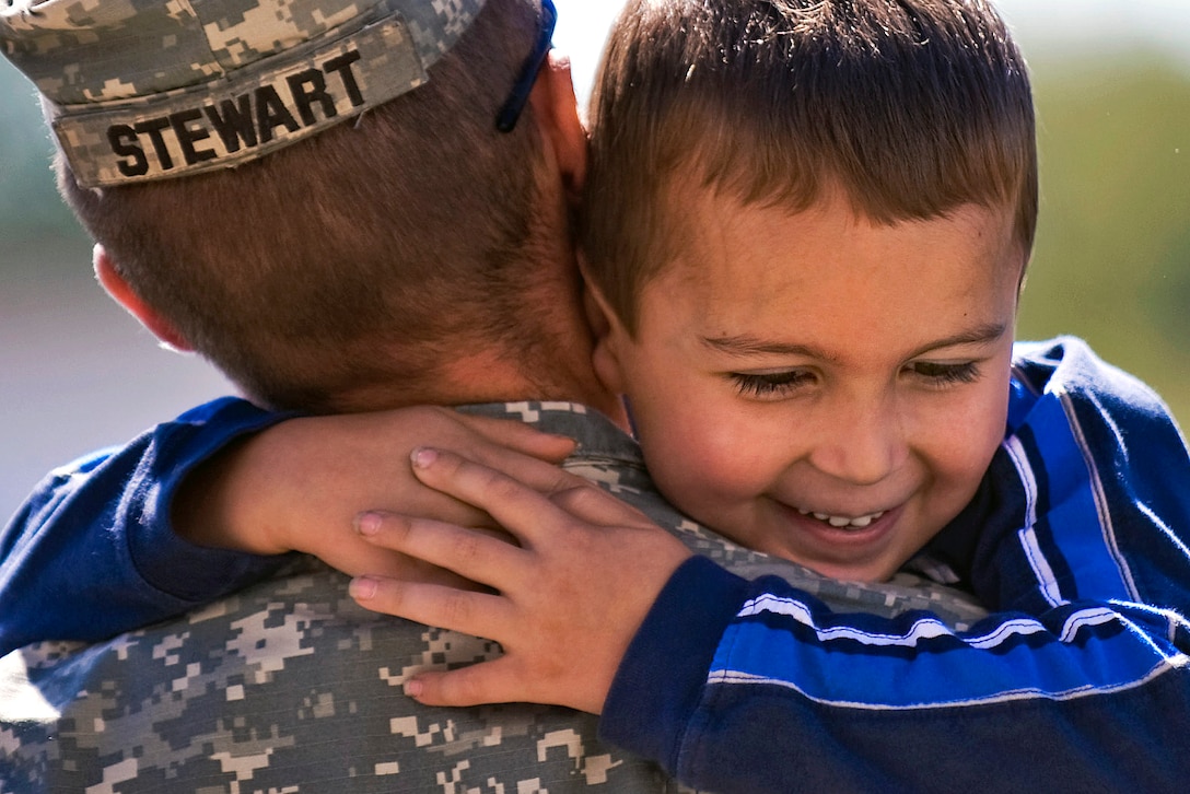 U.S. Army Staff Sgt. Patrick Stewart holds his fiance’s son at the departure ceremony for the 3-19th Agricultural Development Team’s departure ceremony for the Indiana National Guard’s 3-19th Agribusiness Development Team on Camp Atterbury Joint Maneuver Training Center, Ind., Sept. 25, 2010. The Indiana National Guard unit will deploy to Afghanistan to help Afghan leaders improve agricultural practices.