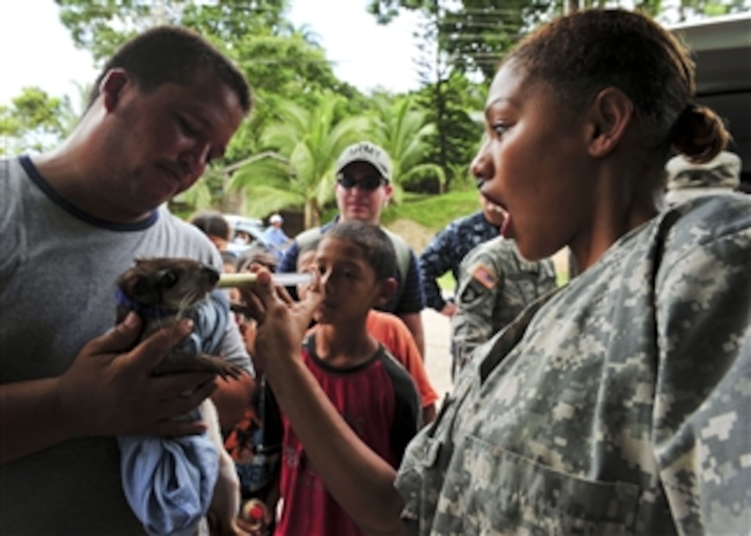 U.S. Army Pfc. Angela McCormick (right), embarked aboard the multipurpose amphibious assault ship USS Iwo Jima (LHD 7), administers a deworming vaccine to a pet during a Continuing Promise 2010 veterinary civic event in Bluefields, Nicaragua, on Sept. 21, 2010.  