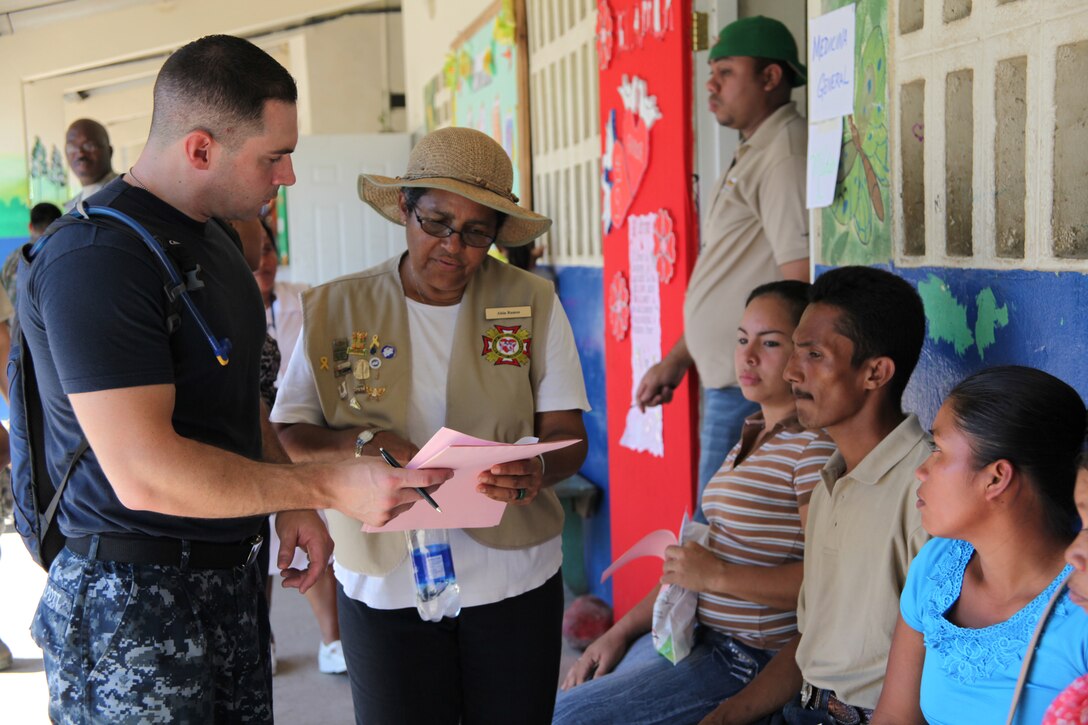 A Navy sailor with Continuing Promise 2010 assists a Panamanian family fill out necessary paperwork to be medically screened at Rambala Maternity Clinic in Punta Pina, Panama, Sept. 28, 2010. The clinic is being used as a medical site for Continuing Promise personnel to conduct medical operations. Marines and Sailors of CP10 are anchored off the coast of Chiriqui Grand, Panama, to conduct humanitarian operations for 10 days. CP10 is a humanitarian civic assistance mission that provides medical, dental, veterinary, engineering support and disaster relief efforts to the Caribbean, Central and South America.