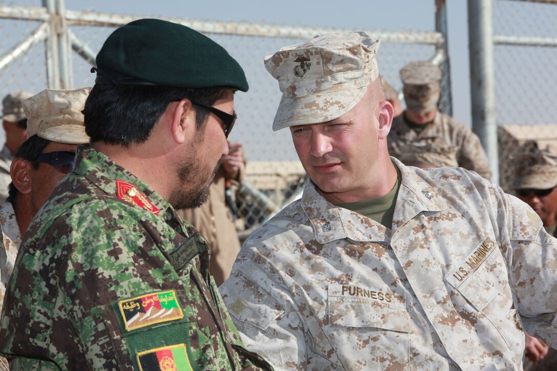 Col. David Furness, the Regimental Combat Team 1 commanding officer, casually converses with guests at RCT 1 and 7’s Relief-in-Place, Transfer-of-Authority ceremony, Sept. 28. During the past year, RCT-7 has helped Afghanistan National Security forces wrest control of central Helmand province away from the Taliban.