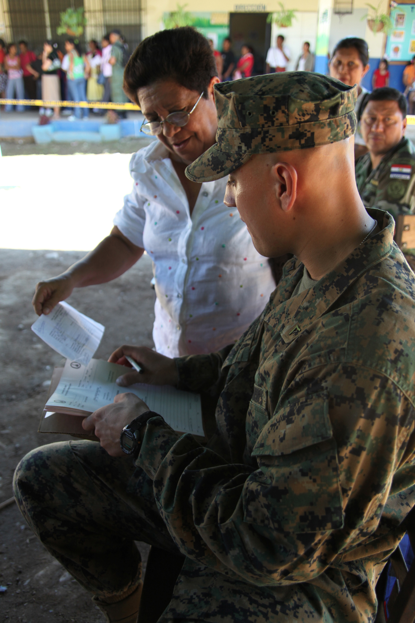 Lance Cpl. Edward R. Argueta, native of Chicago, Ill., and crewman with Company A, 2nd Assault Amphibian Battalion, Ground Combat Element of Special-Purpose Marine Air-Ground Task Force Continuing Promise 2010, fills out paperwork for a Panamanian woman prior to her seeking medical attention at Rambala Maternity Clinic in Punta Pina, Panama, Sept. 28, 2010. The clinic is being used as a medical site for Continuing Promise personnel to conduct medical operations. Marines and Sailors of CP10 are anchored off the coast of Chiriqui Grand, Panama, to conduct humanitarian operations for 10 days. CP10 is a humanitarian civic assistance mission that provides medical, dental, veterinary, engineering support and disaster relief efforts to the Caribbean, Central and South America.