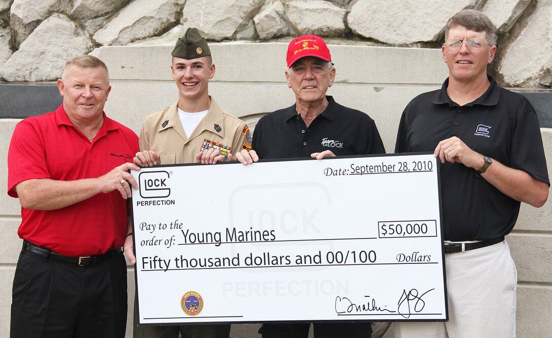 (Left to right) Ret. Lt. Col. Mike Kessler national executive director, Young Marines; Young Marine Sgt. Maj. Casey Scott, Young Marine of the Year; R. Lee Ermey and Josh Dorsey, vice president of GLOCK, inc., hold the check for $50,000 donated to the Young Marines from GLOCK. The Young Marines have used the yearly donation for the past five years for leadership academies for the Young Marines.