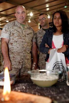 Spectators at the Modern Day Marine Exposition in Quantico, Va., watch Paul Smith, of Ultimate Survival Tech, demonstrate 'Blast Matches,' Sept. 28, 2010. There are three types of matches; Blastmatch, Wetfire and Sparkie. All three are lightweight matches and work in any environment; wet, dry and confined spaces.