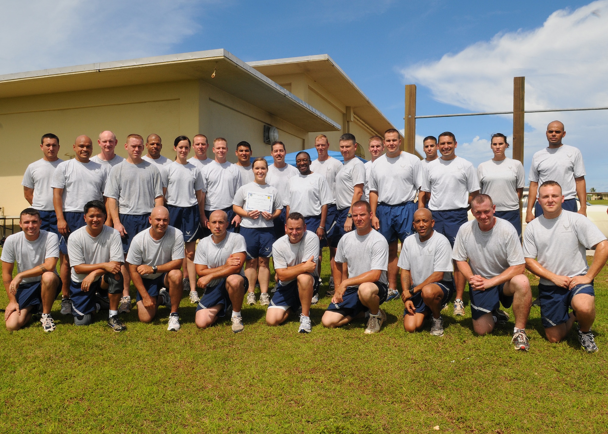 Tech. Sgt. Andrea Inmon, 36th Mobility Response Squadron NCO-in-charge of training, poses for a group photo with her squadron after being awarded Andersen's Best at the 36th MRS, Sept. 27. Sergeant Inmon was recognized by her squadron and wing leadership for her innovative process to manually transfer hard copy training records over to Training Business Area. -the Air Force's computerized on-the-job training records system. (U.S. Air Force photo/ Senior Airman Nichelle Anderson)