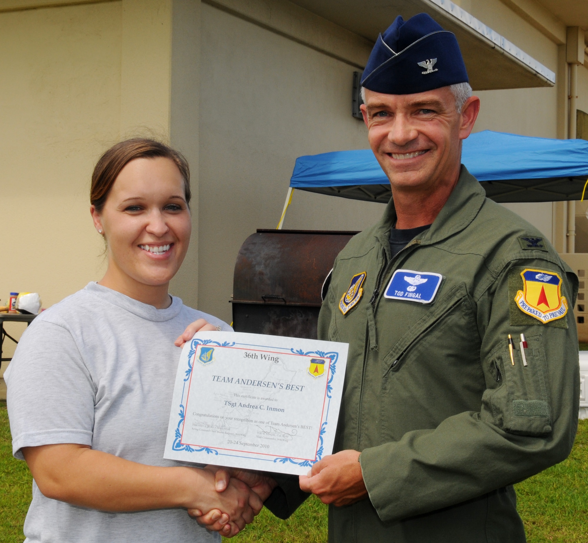 Col. Tod Fingal, 36th Wing vice commander, presents Tech. Sgt. Andrea Inmon, 36th Mobility Response Squadron NCO-in-charge of training, with a certificate after being awarded Andersen's Best at the 36th MRS, Sept. 27. Sergeant Inmon was recognized by her squadron and wing leadership for her innovative process to manually transfer hard copy training records over to Training Business Area, --the Air Forces computerized on the job training records system. (U.S. Air Force photo/ Senior Airman Nichelle Anderson)