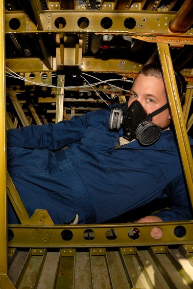 KULIS AIR NATIONAL GUARD BASE, Alaska ? Senior Airman David Eggleston, an aircraft fuels technician, from the 176th Maintenance Squadron is inside a training, C-130 integral fuel tank to demonstrate the size of the work space found in the tank on Sept. 19, 2010. The technicians work in two-member teams with one person inside the tank and another on the outside to hand and trade tools and to provide safety back-up for the person on the inside. During an eight-hour day, technician can work up to four hours inside the tank and it can take a week?s worth of time to complete a repair. Alaska Air National Guard photo by Master Sgt. Shannon Oleson.