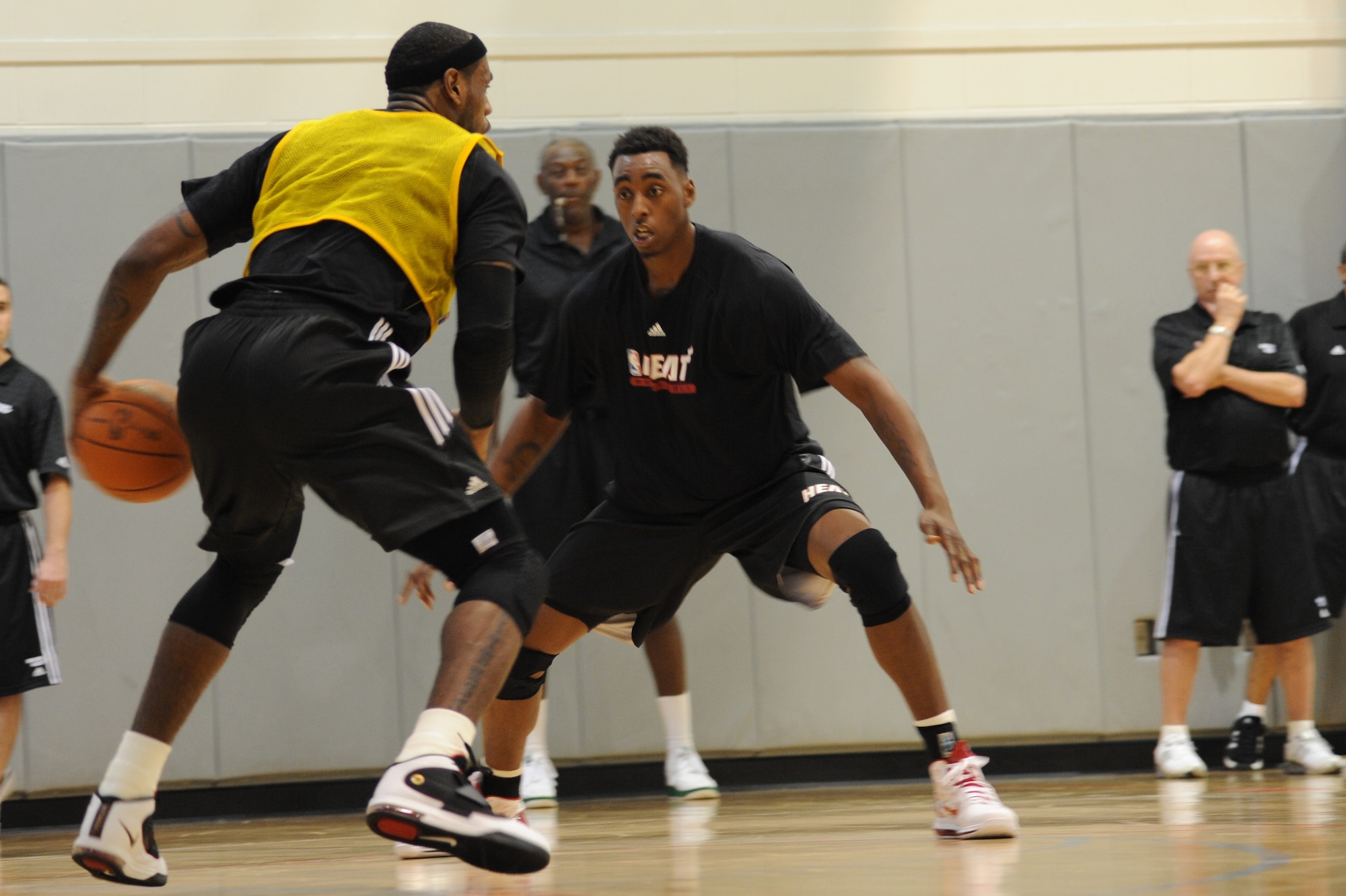 LeBron James, Miami HEAT forward, left, prepares to take the basketball around the defense of Mickell Gladness, HEAT center, during a preseason practice session at the Aderholt Fitness Center at Hurlburt Field, Fla., Sept. 28, 2010. The team requested the use of the fitness center for their week-long training camp, and 1st Special Operations Wing leadership agreed to support the visit. (DoD photo by U.S. Air Force Senior Airman Sheila deVera) (RELEASED)