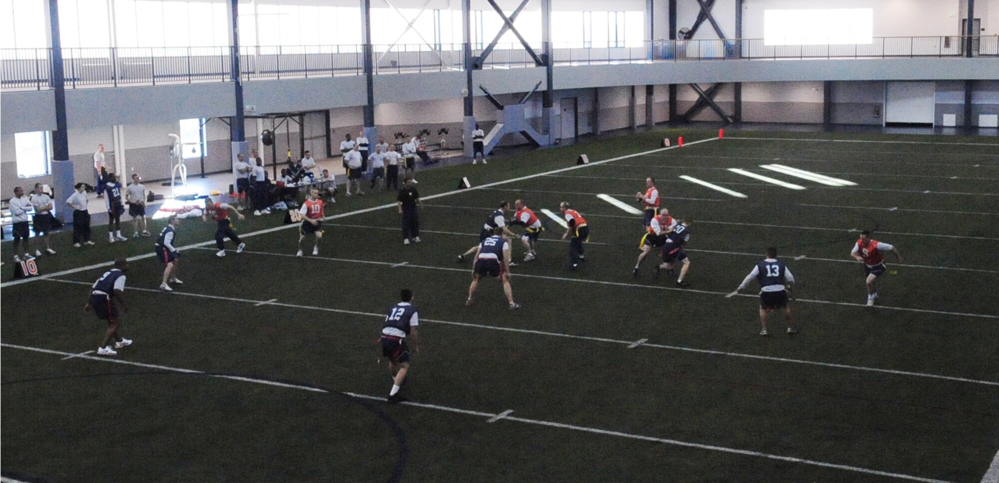 Airmen play flag football during Sports Day at Baker Field House Fitness Center Sept. 24, 2010. There was a variety of indoor and outdoor sports hosted as well as a free lunch funded by the 354th Force Support Squadron. (U.S. Air Force photo/Airman 1st Class Laura Goodgame)