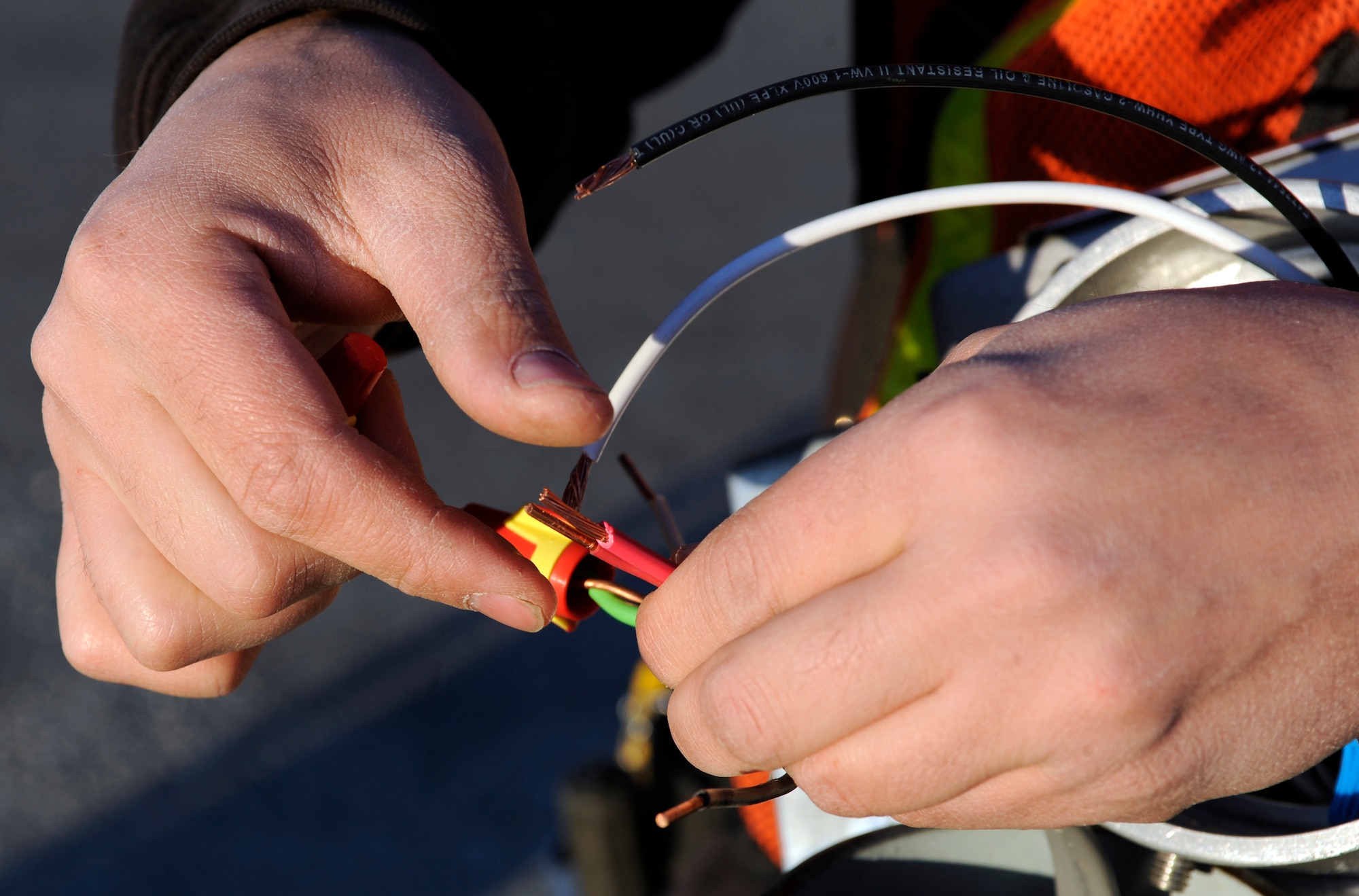 Wes Price fuses wires Sept. 21, 2010, Eielson Air Force Base, Alaska. The wires were being fused in preparation to mount more energy efficient, intelligent head bolt outlets. These outlets are preprogrammed to only fuel vehicle winterizations, other forms of heaters will not have enough energy to run. Mr. Price is an electrician for Salcha Electric. (U.S. Air Force photo/Senior Airman Willard E. Grande II)