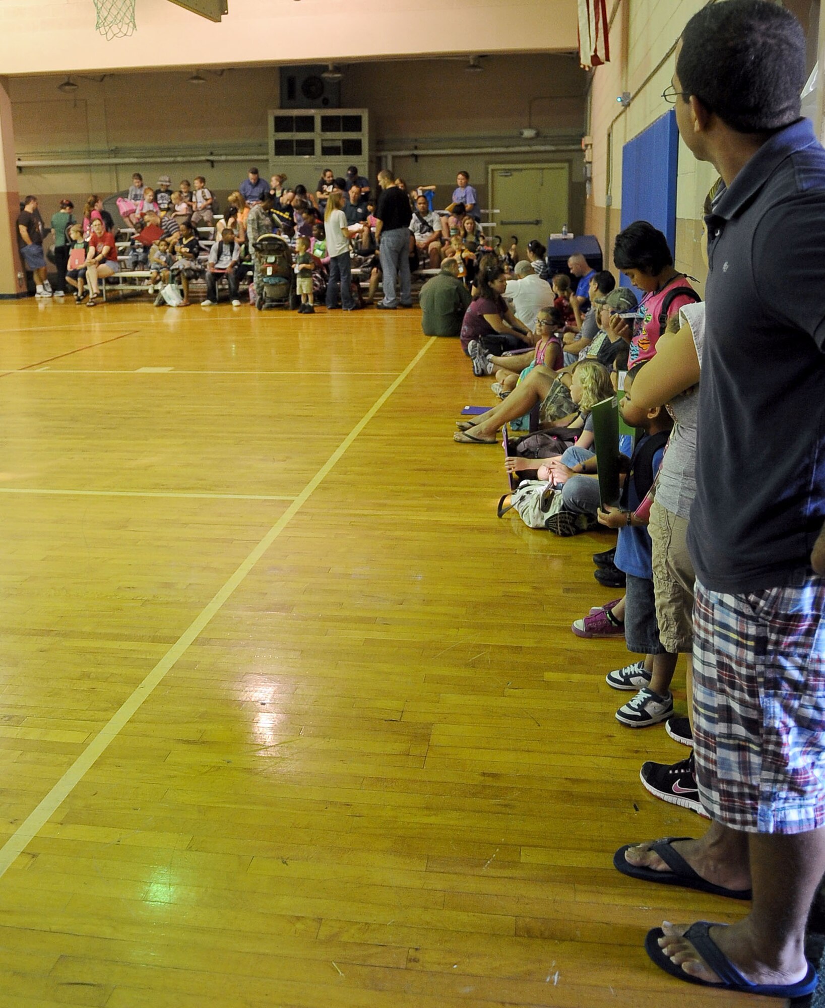 BARKSDALE AIR FORCE BASE, La. - Parents and children wait for a mission brief at the kick off of the annual Operation Hero event, Sept. 25. More than 130 children and 90 parents participated in the mock-deployment line to help children understand what their military parents experience before deploying downrange. Some activities included a weapons qualification with paintball guns, chemical readiness preparation and a physical fitness assessment. (U.S. Air Force photo/Senior Airman Amber Ashcraft) (RELEASED)