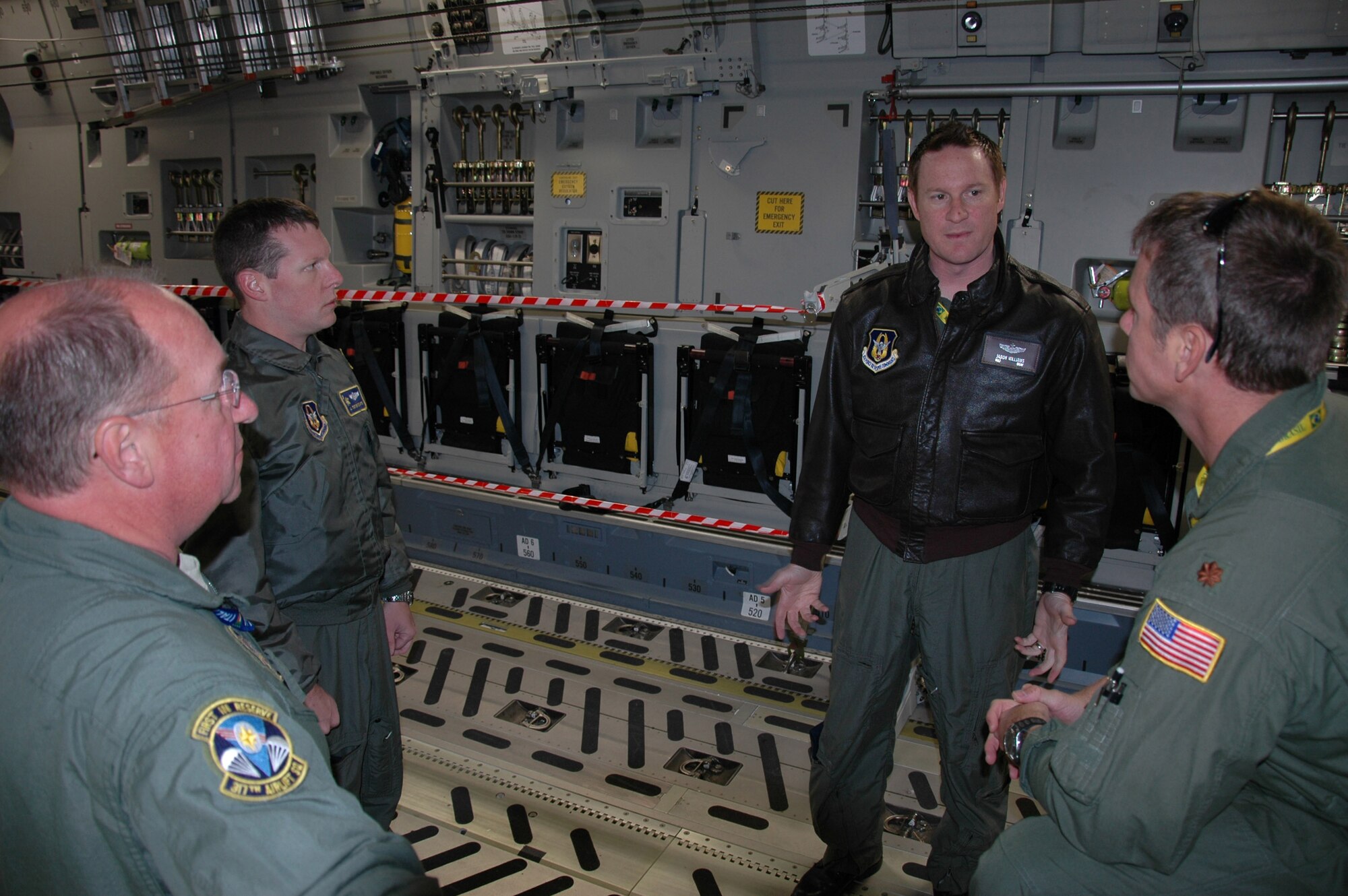 Majors Mike Stratton and Jason Williams along with loadmasters Eric Zilaitis and George Counts, 317th Airlift Squadron Charleston Air Force Base, S.C., discuss the traffic route for visitors to the C-17 static display Sept. 25 during the Africa Aerospace and Defense Expo, Ysterplaat Air Force Base, Cape Town South Africa. The reservists from Charleston introduced the C-17 Globemaster III to thousands of visitors over the five day trade and air show. (U.S. Air Force photo/2nd Lt. Joe Simms)