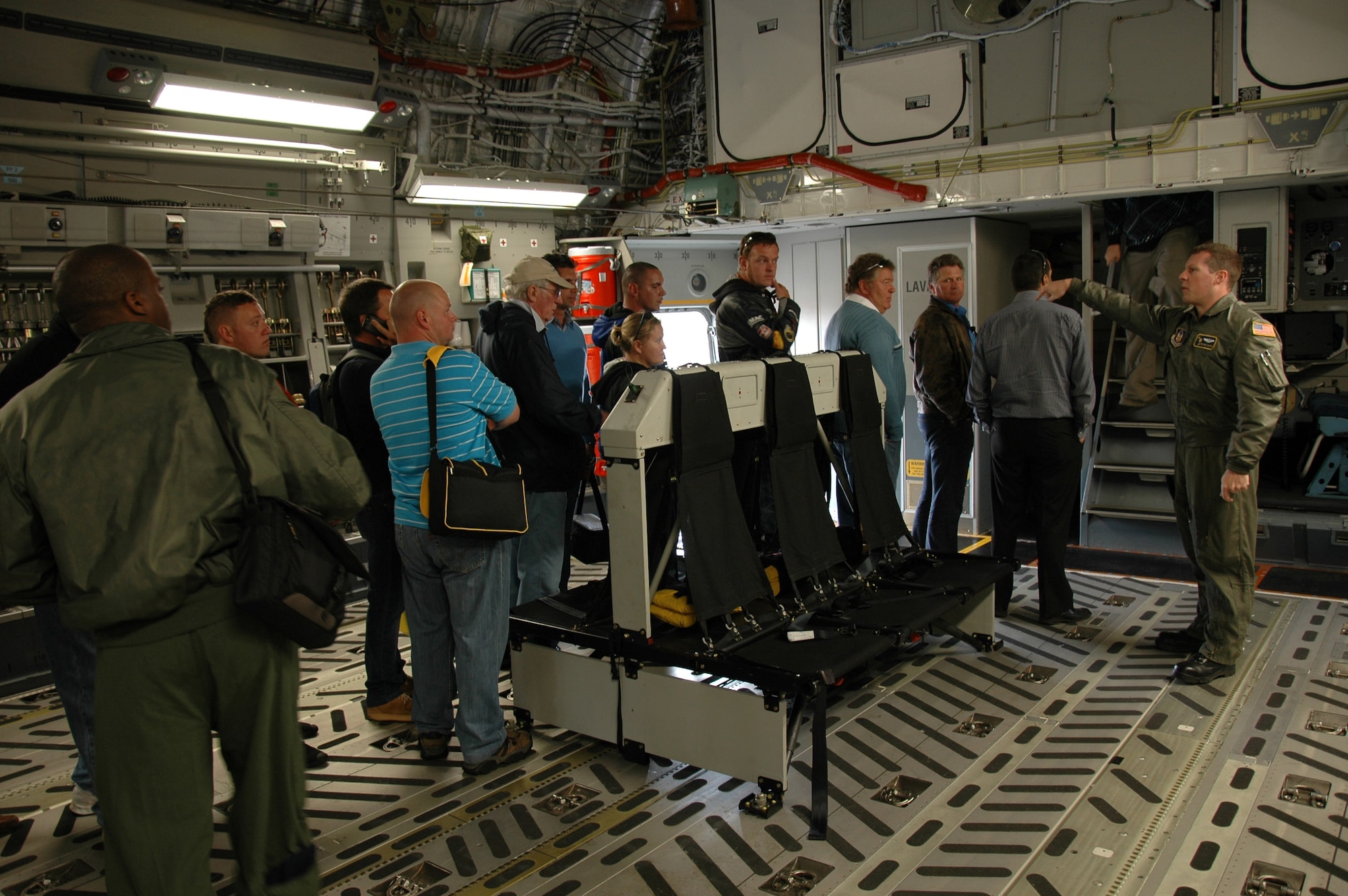 Tech. Sgt.Eric Zilaitis, a loadmaster with the 317th Airlift Squadron, Charleston Air Force Base S.C., leads a tour group through a C-17 Globemaster III static display during the Africa Aerospace and Defense airshow, Ysterplaat Air Force Base, Cape Town, South Africa. Sergeant Zilaitis and a crew of three reservists from the 317th AS answered questions from an international audience on the mission and capablilities of the C-17 Sept 21-25. (U.S. Air Force photo/2nd Lt. Joe Simms)