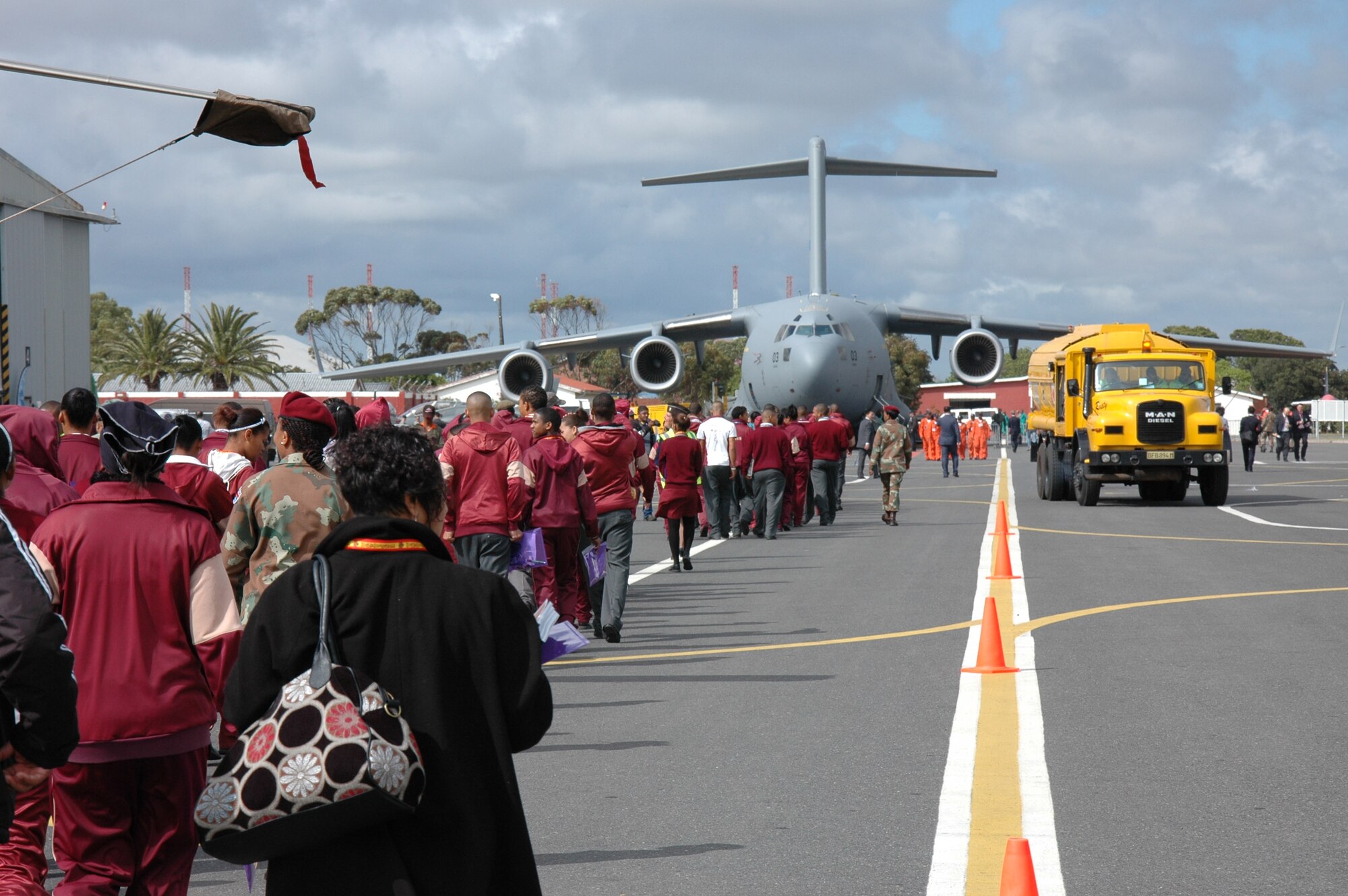 Students and teachers involved in the Africa Aerospace and Defense Youth Development Program make their way to the C-17 Globemaster III static display during the air and trade show held at Ysterplaat Air Force Base, Cape Town South Africa. Members of the 315th Airlift Wing Charelston Air Force Base, S.C., maintained the staic display Sept. 21-25 and shared with local South African students on the missions and capabilities of the C-17. (U.S. Air Force photo/2nd Lt. Joe Simms)