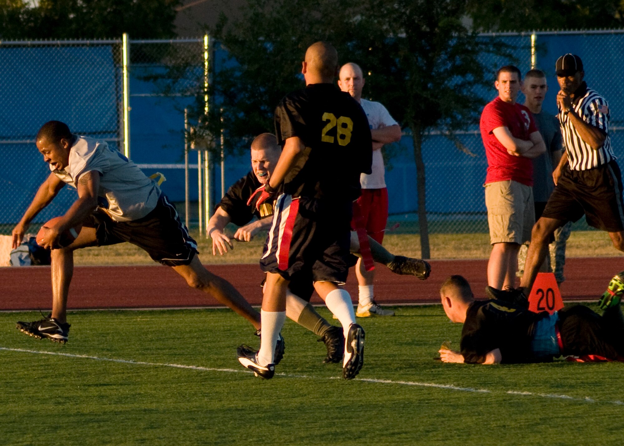 GOODFELLOW AIR FORCE BASE, Texas --  17th Mission Support Group Junk Yard Dog receiver, Michael Thompson, slips out the grasp of 344th Army defenders during intramural play at the base football field Sept. 27. A last second touchdown by Army tied the game at 13-13, forcing overtime. With four downs each, the Junk Yard Dogs were able to outplay Army by 23-yards, helping to secure a 1-point lead. The Dogs advanced to play Army again for the championship. (U.S. Air Force photo/ Senior Airman Tong Duong)