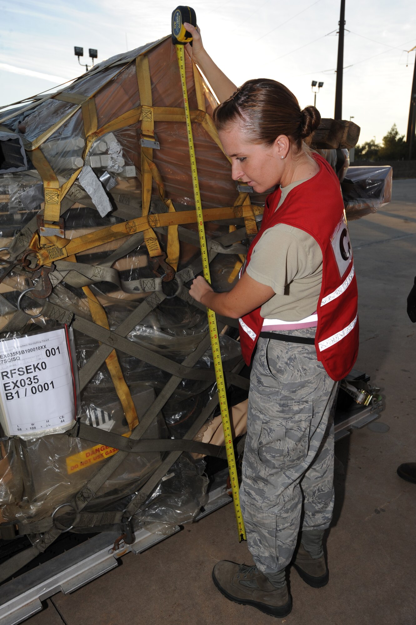 Airman 1st Class Sarah Klasnich, 27th Special Operations Logistics Readiness Squadron, measures the height and width of the cargo to make sure that it fits on the aircraft during an Operational Readiness Exercise Sept. 27. The ORE is ensures Airmen are prepared to deploy and work in a deployed location. (U.S. Air Force photo by Senior Airman Maynelinne De La Cruz)