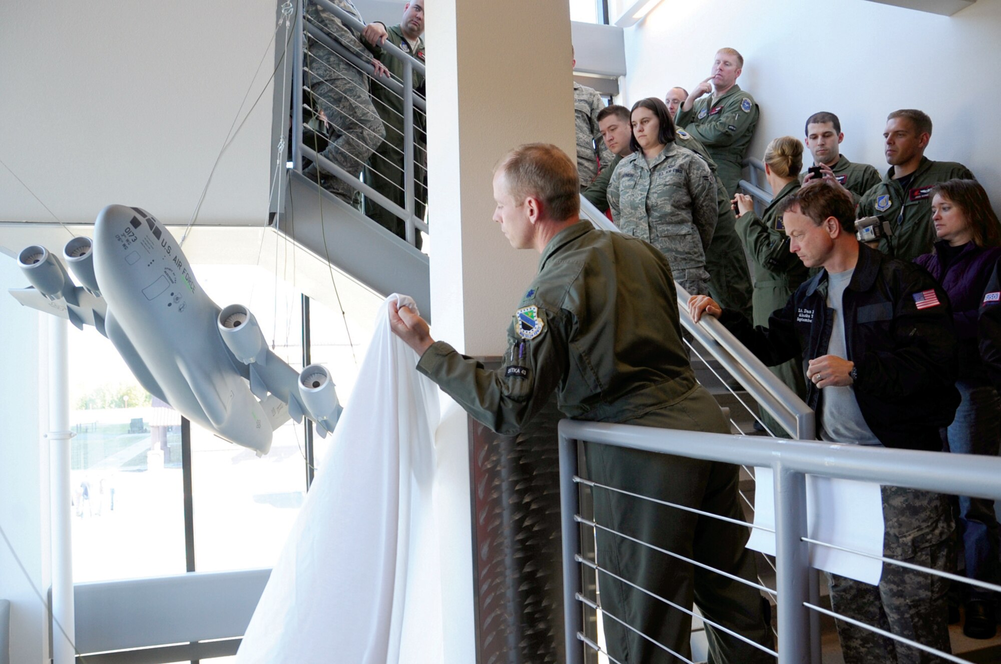 Lt. Col. Patrick Weeks catches the veil that covered the Sitka 43 Memorial model after it was released by actor Gary Sinise Sept. 16, 2010, at Joint Base Elmendorf-Richardson, Alaska. Colonel Weeks is the 517th Airlift Squadron commander. (U.S. Air Force photo/Senior Airman Cynthia Spalding)