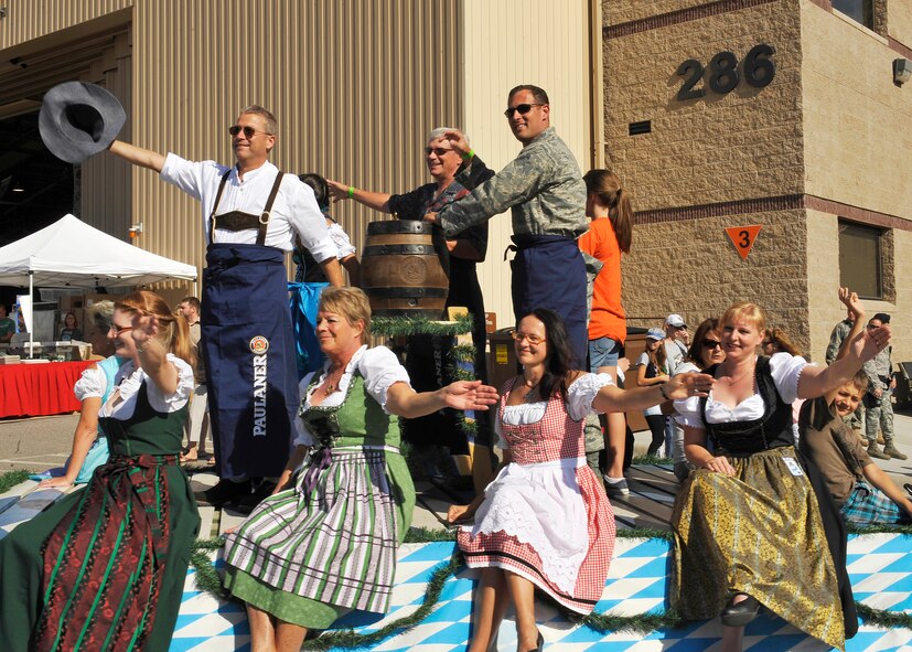 HOLLOMAN AIR FORCE BASE, N.M. -- Col. Frank Kiesel, German Air Force Flying Training Center commander, Ron Griggs, mayor of Alamogordo and Col. David Krumm, 49th Wing commander wave to guests at the 14th Annual Oktoberfest Sept. 25, 2010. The Oktoberfest celebration kicked off with a parade that included the musical band Die Lustigen Eyachtaler followed by the tapping of the first keg. (U.S. Air Force photo by Senior Airman Veronica Stamps / Released)