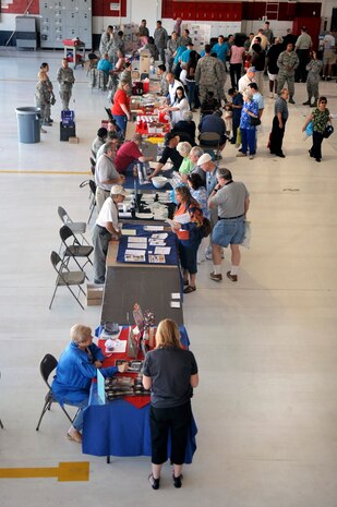 NELLIS AIR FORCE BASE, Nev.--  Retirees gather at the Nellis, Creech and Nevada Test and Training Range Retiree Appreciation Day Sept. 25. The event included health screenings, K-9 and explosive ordnance disposal demonstrations, entertainment, door prizes and a free lunch for more than 800 attendees at the Thunderbird hangar. (U.S. Air Force photo / Staff Sgt. Richard Rose)