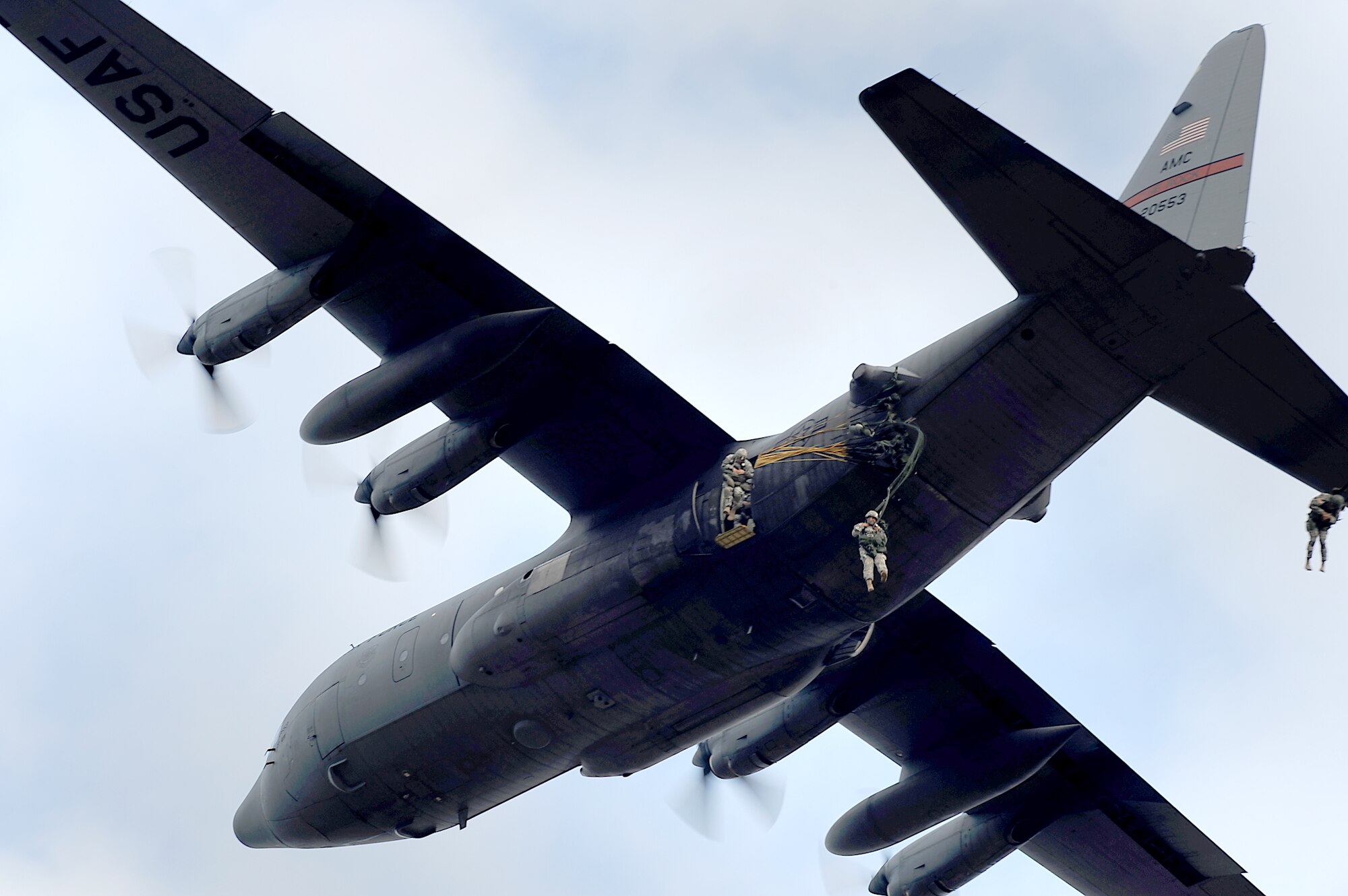 Soldiers jump from the troop door of a C-130 Hercules over a drop zone during airborne operations Sept. 12, 2010, at Fort Bragg, N.C. Soldiers are assigned to the 82nd Airborne Division at Fort Bragg.  (U.S. Air Force photo/Master Sgt. Jeremy Lock) 