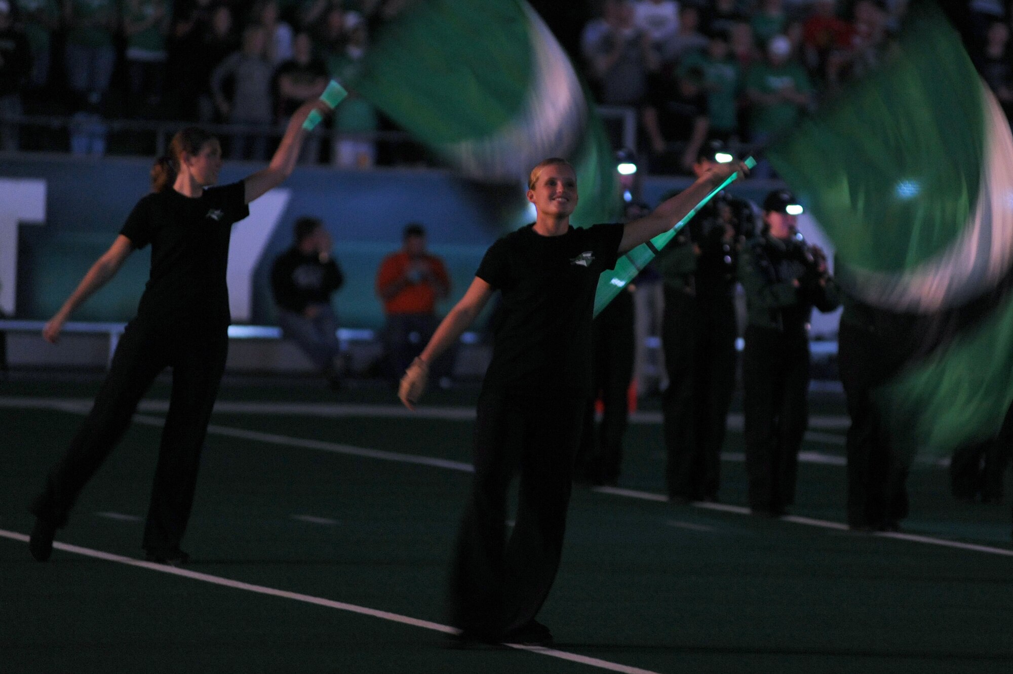 A member from the University of North Dakota color guard performs a routine before the start of the military appreciation football game Sept. 25 at the Alerus Center in Grand Forks, N.D. The Grand Forks Chamber of Commerce Military Affairs Committee supplied food and tickets to military members and their families. The UND Fighting Sioux defeated the Northwestern State University Demons 49-24. (U.S. Air Force photo by Senior Airman Amanda N. Stencil)