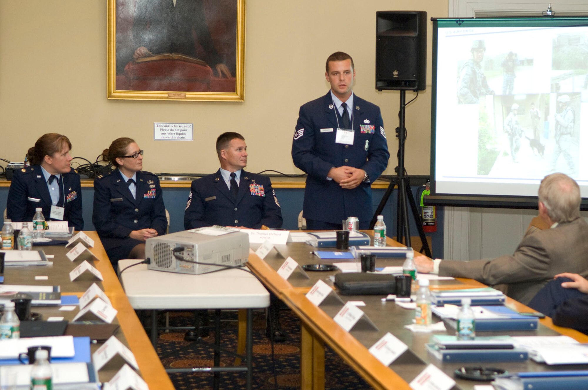 MEDFORD, Mass. – Staff Sgt. Elliot Guenard (standing), a Military Working Dog handler in the 66th Security Forces Squadron, speaks to a group of Air Force senior leaders and scholars during the National Security Scholars Conference at Tufts University on Sept. 23. Sergeant Guenard, along with three other Airmen, were chosen to discuss contributions to the joint fight during recent deployments. (U.S. Air Force photo by Mark Wyatt)