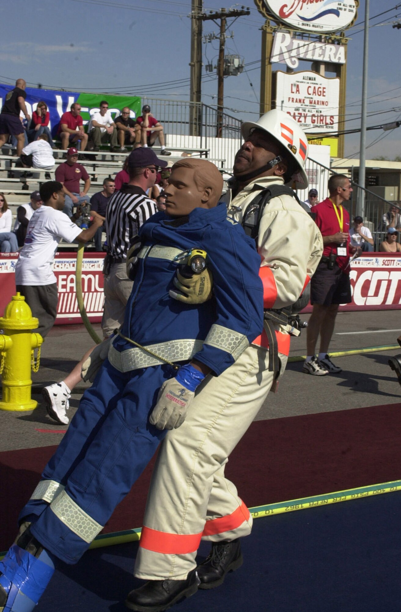 RAF MILDENHALL, England -- A former RAF Mildenhall firefighter drags a 175-pound mannequin towards the finish line at the 2004 Firefighter Combat Challenge. The dummy drag/victim rescue is one of many events in this year's fire muster Oct. 7 at the fire department here, held as part of Fire Prevention Week. (U.S. Air Force file photo/Karen Abeyasekere)