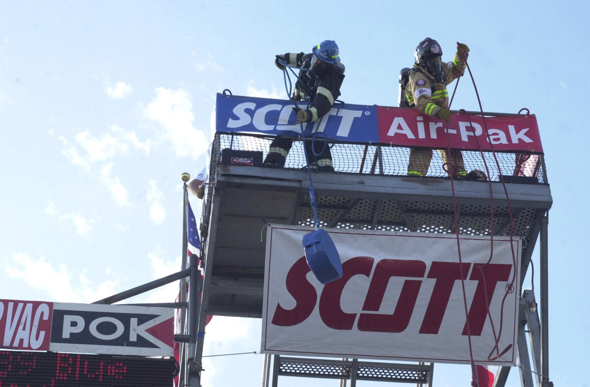 RAF MILDENHALL, England -- A former RAF Mildenhall firefighter (left) competes against a firefighter from a civilian fire department in the hose hoist portion of the Firefighter Combat Challenge in Las Vegas, Nev., in 2004. The hose hoist is just one of the events in the Oct. 7 fire muster held here as part of Fire Prevention Week. (U.S. Air Force file photo/Karen Abeyasekere)