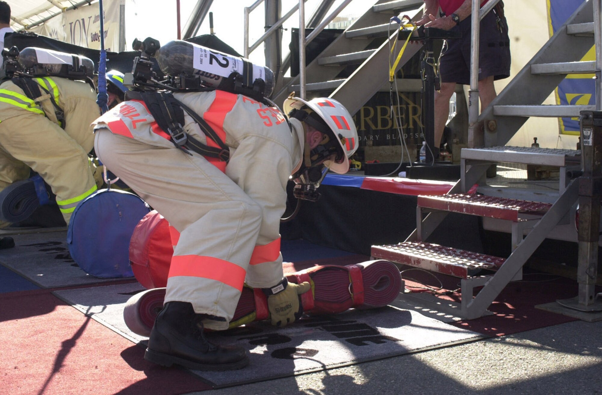 RAF MILDENHALL, England -- A former 100th Civil Engineer Squadron commander prepares to pick up a hosepack and run up six flights of stairs at the start of the Firefighter Combat Challenge World Challenge XIII in November 2004 in Las Vegas, Nev. This is just one of the events in RAF Mildenhall's Fire Muster event Oct. 7 here as part of Fire Prevention Week. (U.S. Air Force file photo/Karen Abeyasekere)