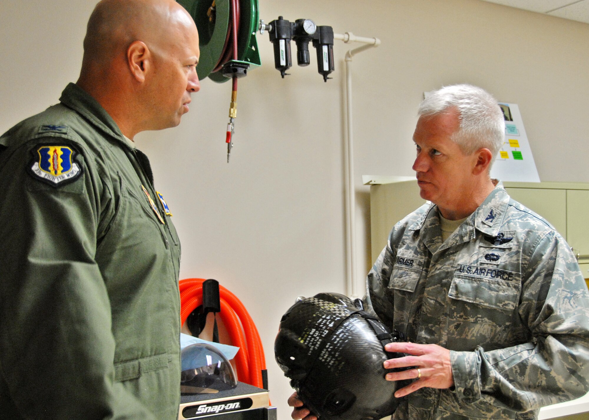 Col. David Htlacky, 33rd Fighter Wing commander, discusses the latest F-35 equipment innovations with his predecessor Col. Todd Harmer, former 33 FW commander, Sept 21 at Eglin Air Force Base, Fla.  (U.S. Air Force photo/Samuel King Jr.)