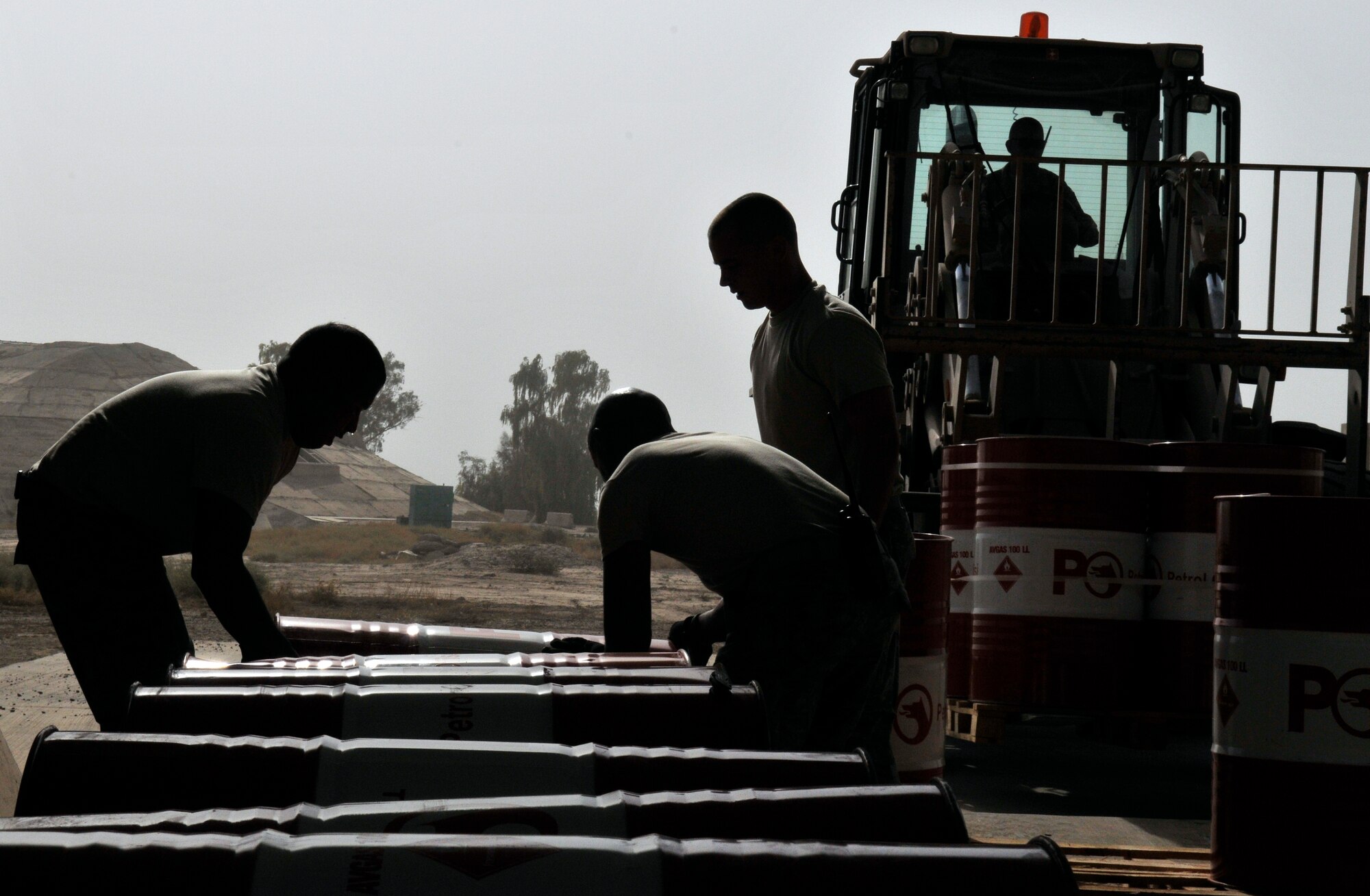 332nd Expeditionary Logistics Readiness Squadron fuels technicians roll barrels of aviation gas off a forklift for storage Sept. 24, 2010, Joint Base Balad, Iraq. The annual U.S. usage of AvGas was 186 million gallons in 2008. The barrels are stored on their sides to ease the stress on the barrels when the gas expands in the heat. (U.S. Air Force photo/Staff Sgt. Phillip Butterfield) 