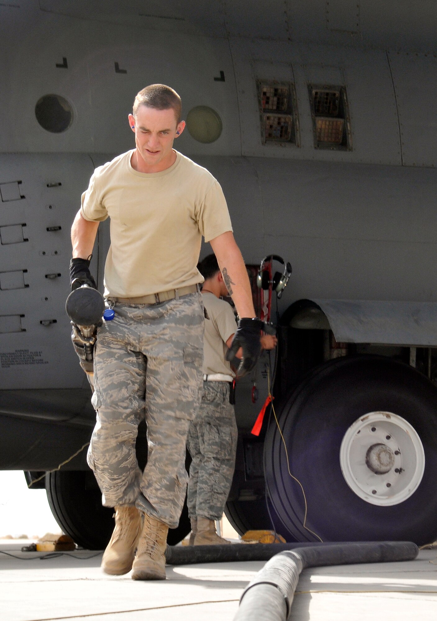 Senior Airman Stuart Brennan, 332nd Expeditionary Logistics Readiness Squadron fuels distribution technician, drags an aircraft refueling hose back to his fuel truck after a refueling a C-130 Hercules Sept. 24, 2010, Joint Base Balad, Iraq. In 1996, the U.S. military switched from jet propellant 4 to JP-8, which is less hazardous and has higher combat survivability. Airman Brennan is a native of Westerly, R.I., deployed from Shaw Air Force Base, S.C. (U.S. Air Force photo/Staff Sgt. Phillip Butterfield) 