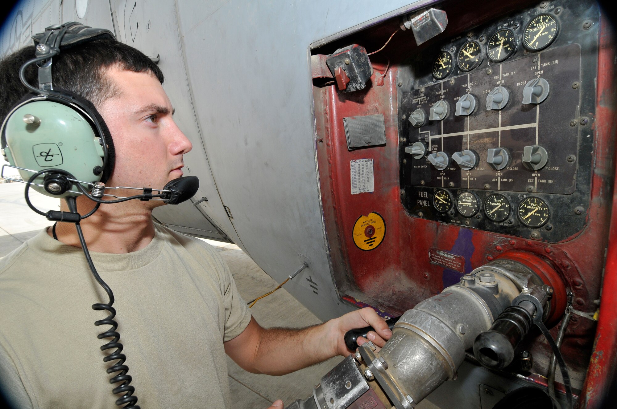 Senior Airman Robert Cipriani, 777th Expeditionary Airlift Squadron crew chief, monitors fuel tank gauges on a C-130 Hercules for proper fuel distribution as approximately 11,000 gallons of fuel are pumped Sept. 24, 2010, Joint Base Balad, Iraq. JBB’s non-piston powered aircraft use jet propellant 8. Airman Cipriani is a native of Melborne, Fla., deployed from Little Rock Air Force Base, Ark. (U.S. Air Force photo/Staff Sgt. Phillip Butterfield) 