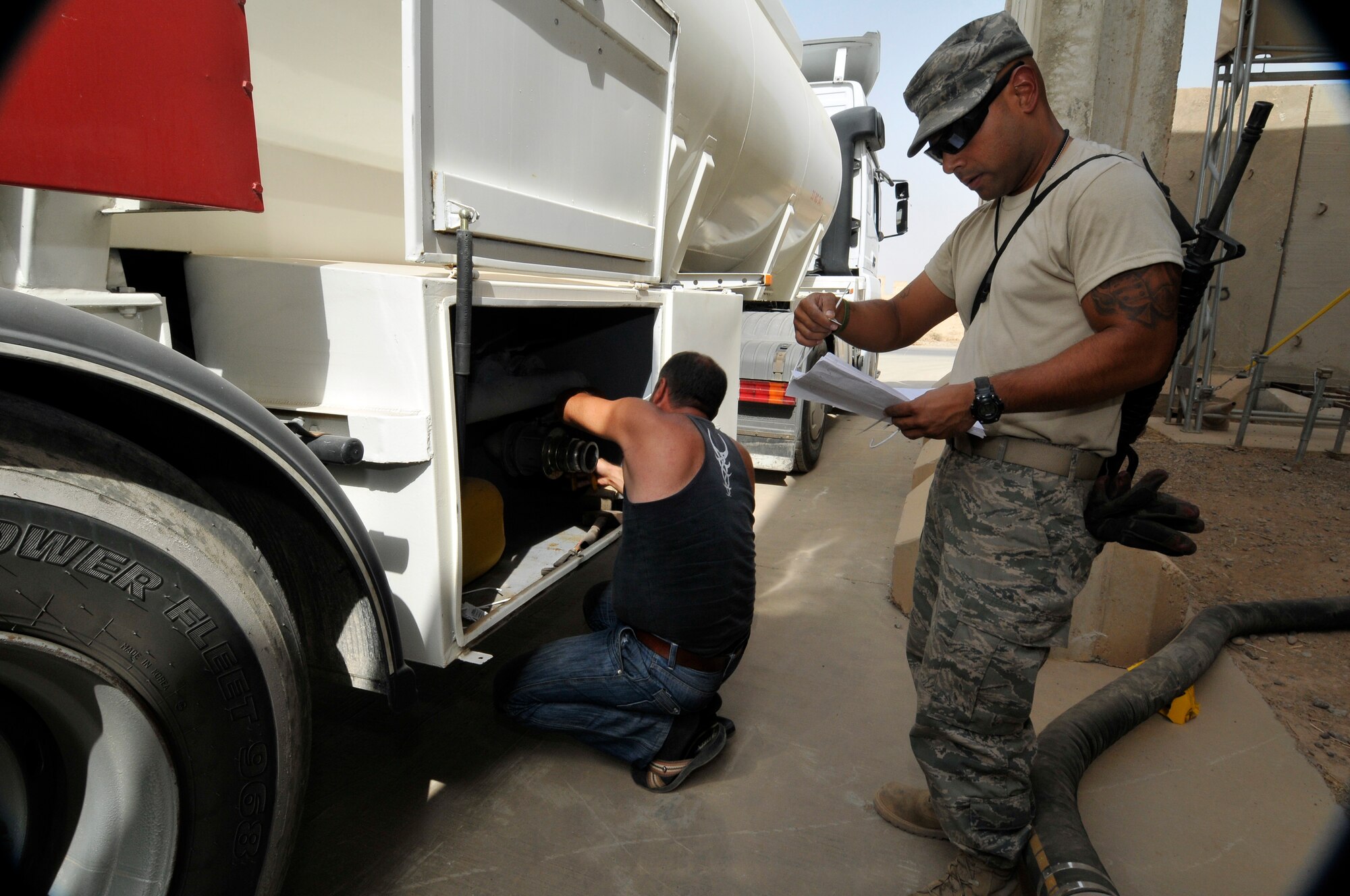 Staff Sgt. Anthony Ochoa, 332nd Expeditionary Logistics Readiness Squadron aviation gas operations NCO in charge, checks the security tags against a tag list to ensure the AvGas delivery truck wasn’t tampered with Sept. 24, 2010, Joint Base Balad, Iraq. AvGas is a high-octane aviation fuel used to power aircraft and racing cars. Sergeant Ochoa is a native of Las Vegas, Nev., deployed from Nellis Air Force Base, Nev. (U.S. Air Force photo/Staff Sgt. Phillip Butterfield) 