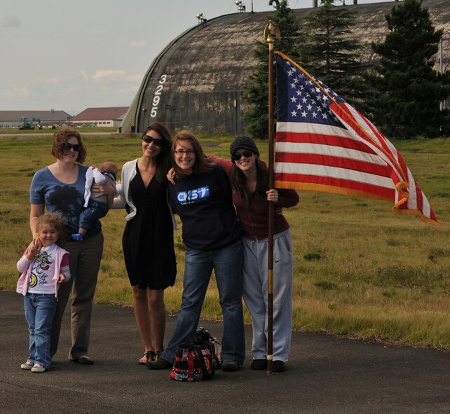 Family members of the 13th Fighter Squadron, assemble on the runway as their service members deploy from Misawa Air Base, Japan, in support of Operation New Dawn, Sept. 27, 2010. The family members of the unit gather together to support their deploying spouses as well as each other. (U.S. Air Force photo by Tech. Sgt. Russell McBride/Released)
