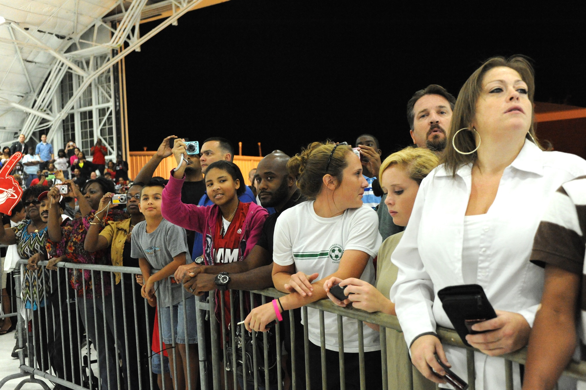 Fans await the arrival of the Miami HEAT at Eglin Air Force Base, Fla., for their 2010 Training Camp at Hurlburt Field, Fla., Sep. 27, 2010. This is the first time in 23 years the HEAT has taken their training camp on the road.  Hurlburt Field will host the team's contingent of 44 from Sep. 28, through Oct. 3, 2010.  (DoD photo by Airman 1st Class Caitlin O'Neil-McKeown)
