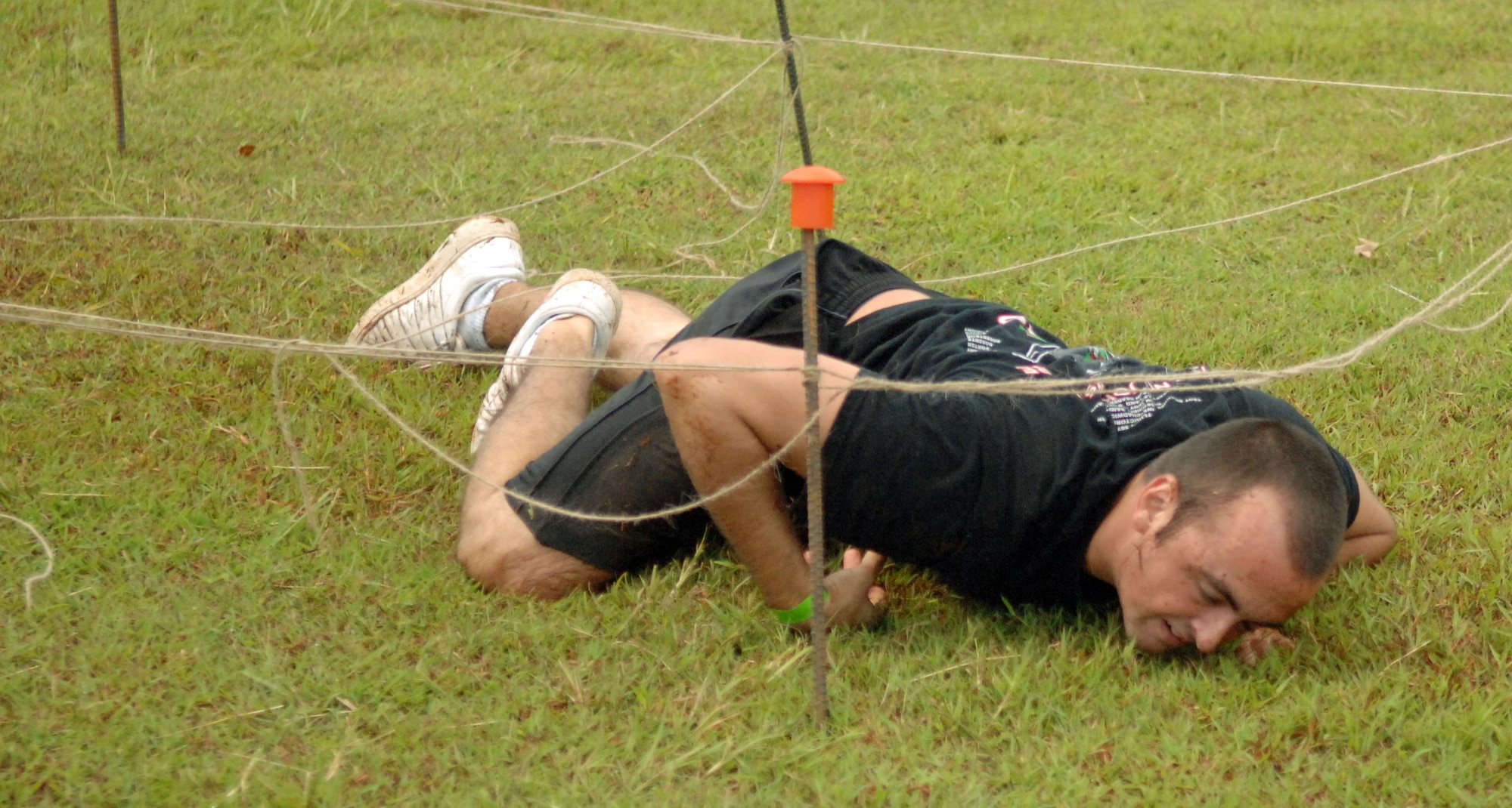 Airman 1st Class Alex Roberts, 36thMedical Group Aerospace Medical Technician, low-crawls through a portion of Andersen Air Force Base’s  Fear Factor obstacle course in the hope of advancing to the semi-final round of competition. The winner of the Fear Factor challenge receives round-trip airfare to Japan. (U.S. Air Force photo/Airman Whitney Amstutz)
