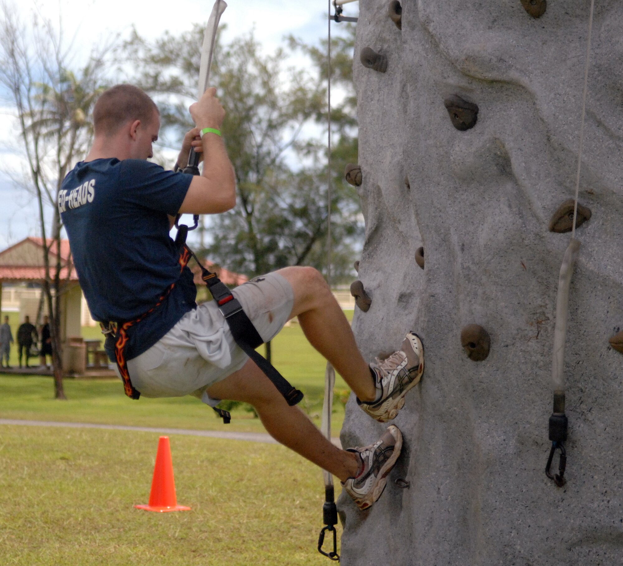 Airman 1st Class Michael Martin, 36thMedical Group Aerospace Medical Technician, scales a 25-foot rock wall in the hopes of becoming Andersen Air Force Base’s Annual Fear Factor champion Sept. 25 at Arc Light Memorial Park. More than 20 servicemembers, dependents and civilians came out for a chance to prove for them, fear is not a factor and walk away with the grand prize of round-trip airfare to Japan. (U.S. Air Force photo/Airman Whitney Amstutz)