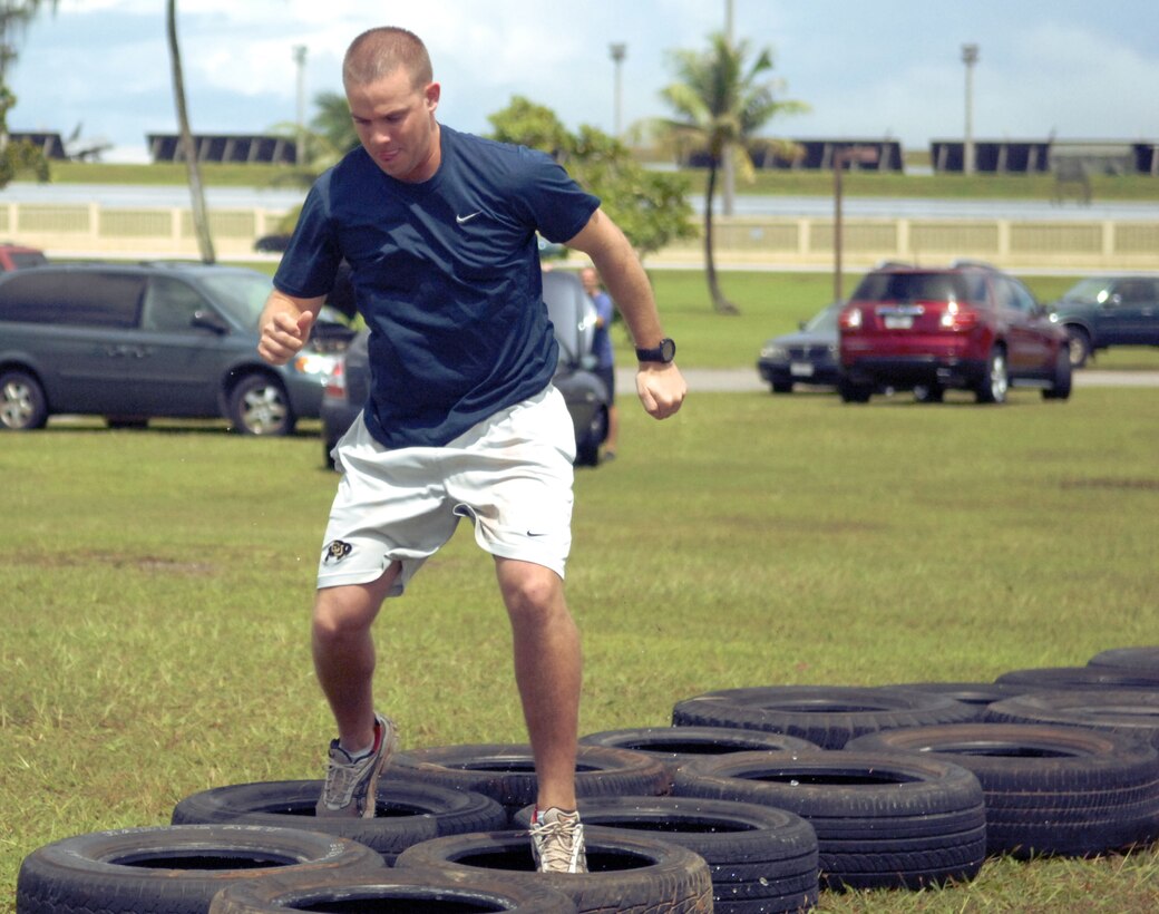 Airman 1st Class Michael Martin, 36thMedical Group Aerospace Medical Technician, completes the tire obstacle course in the hopes of becoming Andersen Air Force Base’s Annual Fear Factor champion Sept. 25 at Arc Light Memorial Park. The competition includes a preliminary qualifying round and three subsequent elimination rounds with a grand prize of round-trip airfare to Japan. (U.S. Air Force photo/Airman Whitney Amstutz)