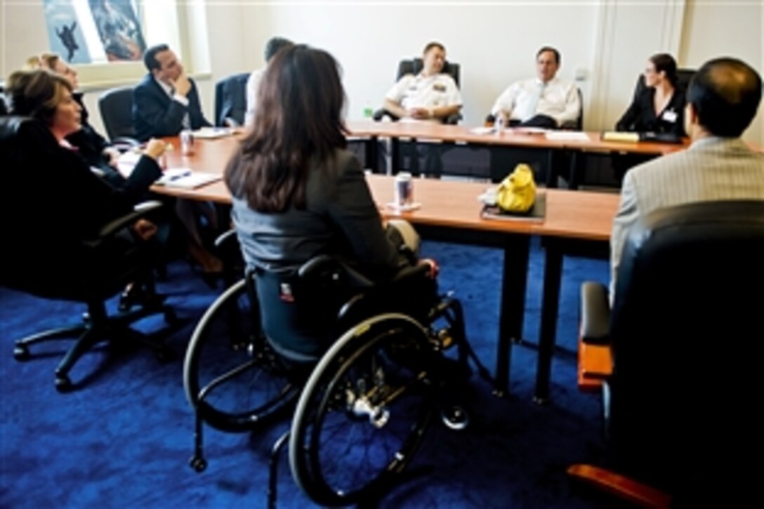Assistant Secretary of  Defense for Public Affairs Doug Wilson, third from right, and his team meet with Veterans Affairs Assistant Secretary Tammy Duckworth, center, and her team to discuss mutual areas of support for veterans and their families at the Pentagon, Sept. 28, 2010.  Duckworth, a major in the Illinois National Guard, is an Army veteran who lost her legs in the Iraq war.
